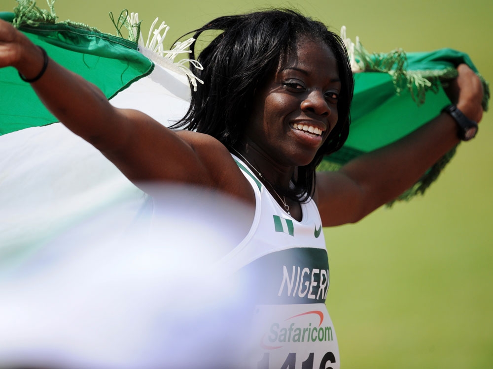 Seun Adigun of Nigeria celebrates with the Nigerian flag after crossing the finish line in first place in the Women's 100 meters Hurdles final during the five day 17th African Athletics Champioships in Nairobi, on July 29, 2010 Seun Adigun of Nigeria celebrates with the Nigerian flag after crossing the finish line in first place in the Women's 100 meters Hurdles final during the five day 17th African Athletics Champioships in Nairobi, on July 29, 2010