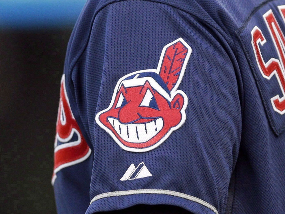 In this April 8, 2014 photo, the Cleveland Indians Chief Wahoo logo is shown on the uniform sleeve of third base coach Mike Sarbaugh during a baseball game against the San Diego Padres in Cleveland, Ohio In this April 8, 2014 photo, the Cleveland Indians Chief Wahoo logo is shown on the uniform sleeve of third base coach Mike Sarbaugh during a baseball game against the San Diego Padres in Cleveland, Ohio