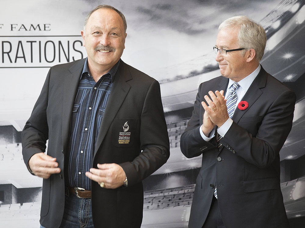 Seven time Stanley Cup winner Bryan Trottier, left, is applauded by the chair of the Board of Governors for Canadian Sports Hall of Fame Colin MacDonald, after being presented with his jacket, following his induction into Canada's Sports Hall of Fame , in Toronto on Tuesday, November 1, 2016. (THE CANADIAN PRESS/Chris Young) Seven time Stanley Cup winner Bryan Trottier, left, is applauded by the chair of the Board of Governors for Canadian Sports Hall of Fame Colin MacDonald, after being presented with his jacket, following his induction into Canada's Sports Hall of Fame , in Toronto on Tuesday, November 1, 2016. (THE CANADIAN PRESS/Chris Young)