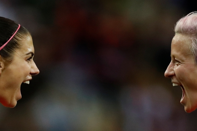  Alex Morgan of the U.S. celebrates scoring her team’s 12th goal against Thailand along with Megan Rapinoe.