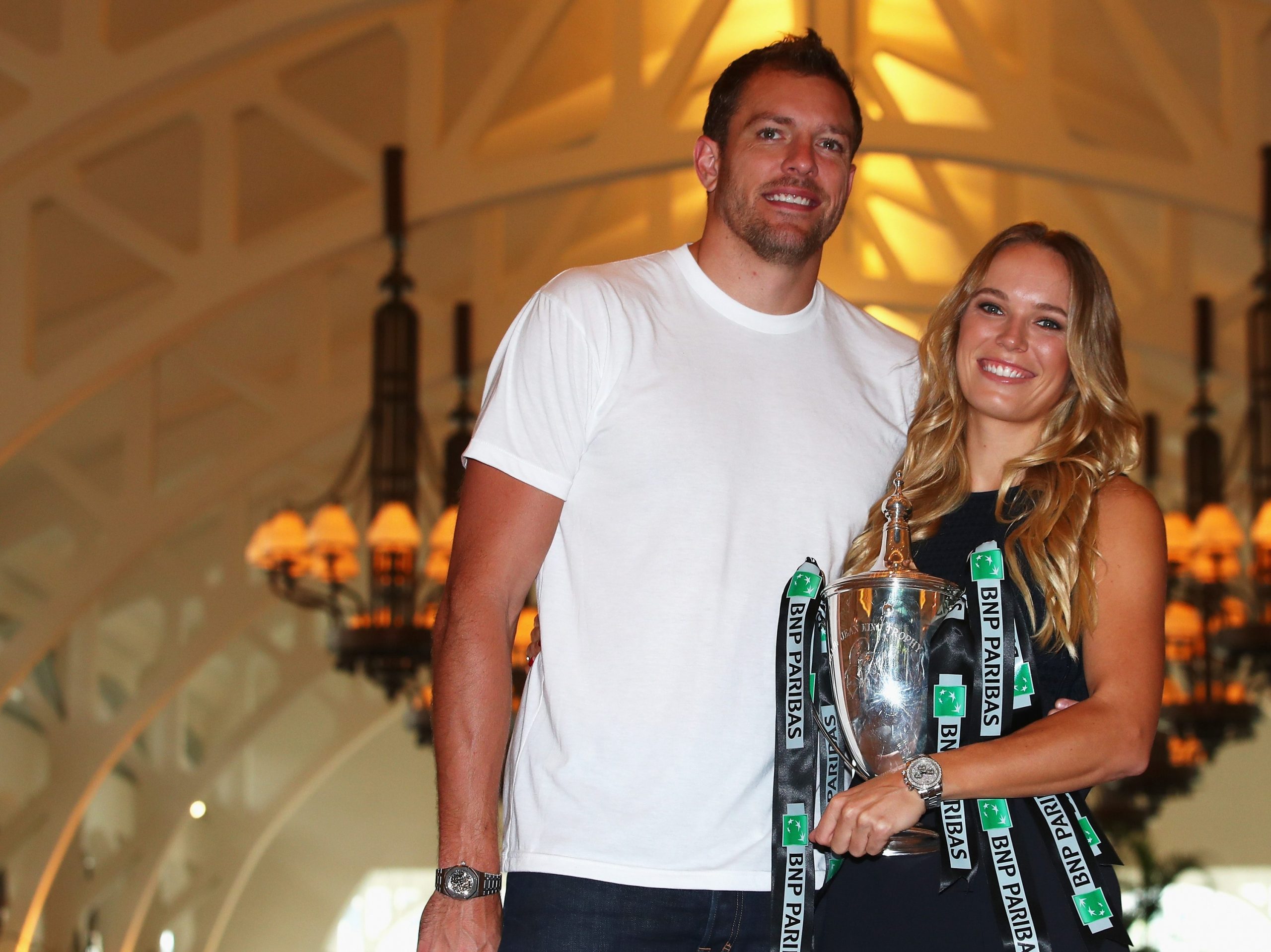 Champion Caroline Wozniacki poses with the Billie Jean King trophy and professional basketball player David Lee after her victory against Venus Williams in the final of the BNP Paribas WTA Finals Singapore presented by SC Global at Clifford Pier on Oct. 30, 2017 in Singapore. (Clive Brunskill/Getty Images) Champion Caroline Wozniacki poses with the Billie Jean King trophy and professional basketball player David Lee after her victory against Venus Williams in the final of the BNP Paribas WTA Finals Singapore presented by SC Global at Clifford Pier on Oct. 30, 2017 in Singapore. (Clive Brunskill/Getty Images)