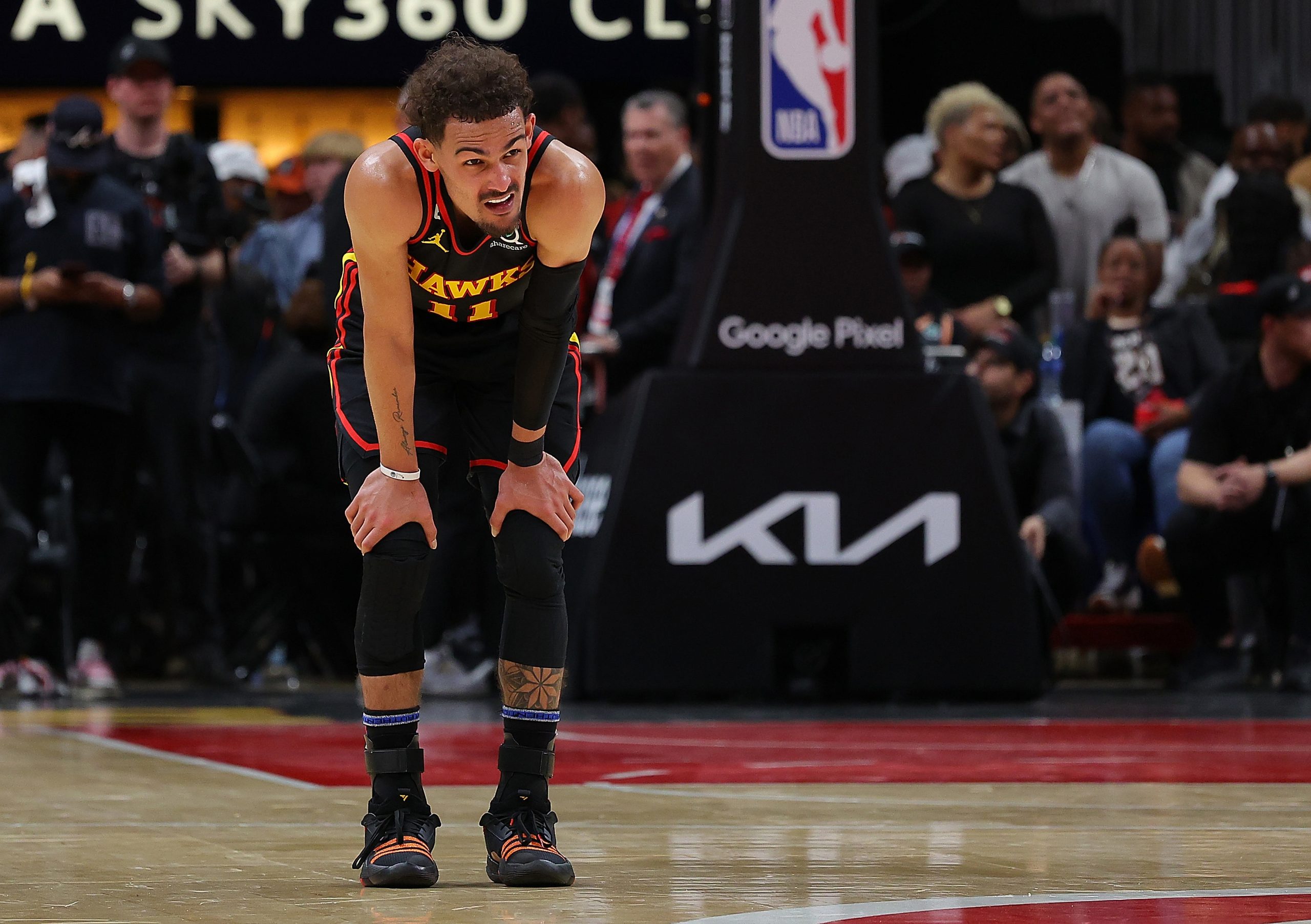 ATLANTA, GEORGIA - APRIL 27: Trae Young #11 of the Atlanta Hawks reacts after battling for a loose ball against Jayson Tatum #0 of the Boston Celtics during the fourth quarter of Game Six of the Eastern Conference First Round Playoffs at State Farm Arena on April 27, 2023 in Atlanta, Georgia. NOTE TO USER: User expressly acknowledges and agrees that, by downloading and or using this photograph, User is consenting to the terms and conditions of the Getty Images License Agreement. (Photo by Kev