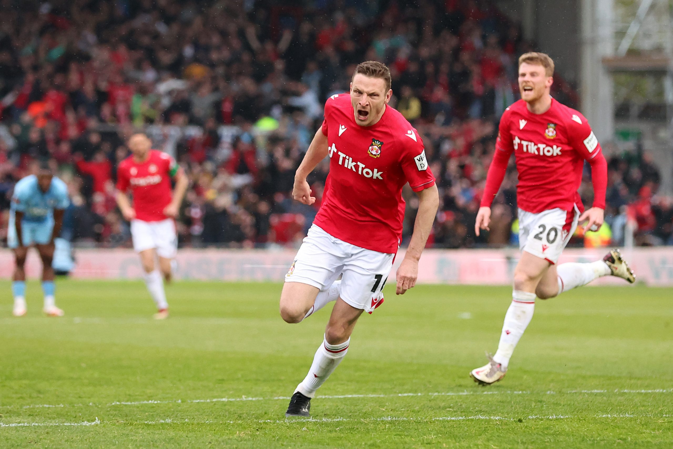 Paul Mullin of Wrexham celebrates after scoring the team's second goal during the Vanarama National League match between Wrexham and Boreham Wood at Racecourse Ground on April 22, 2023 in Wrexham, Wales. (Photo by Jan Kruger/Getty Images)