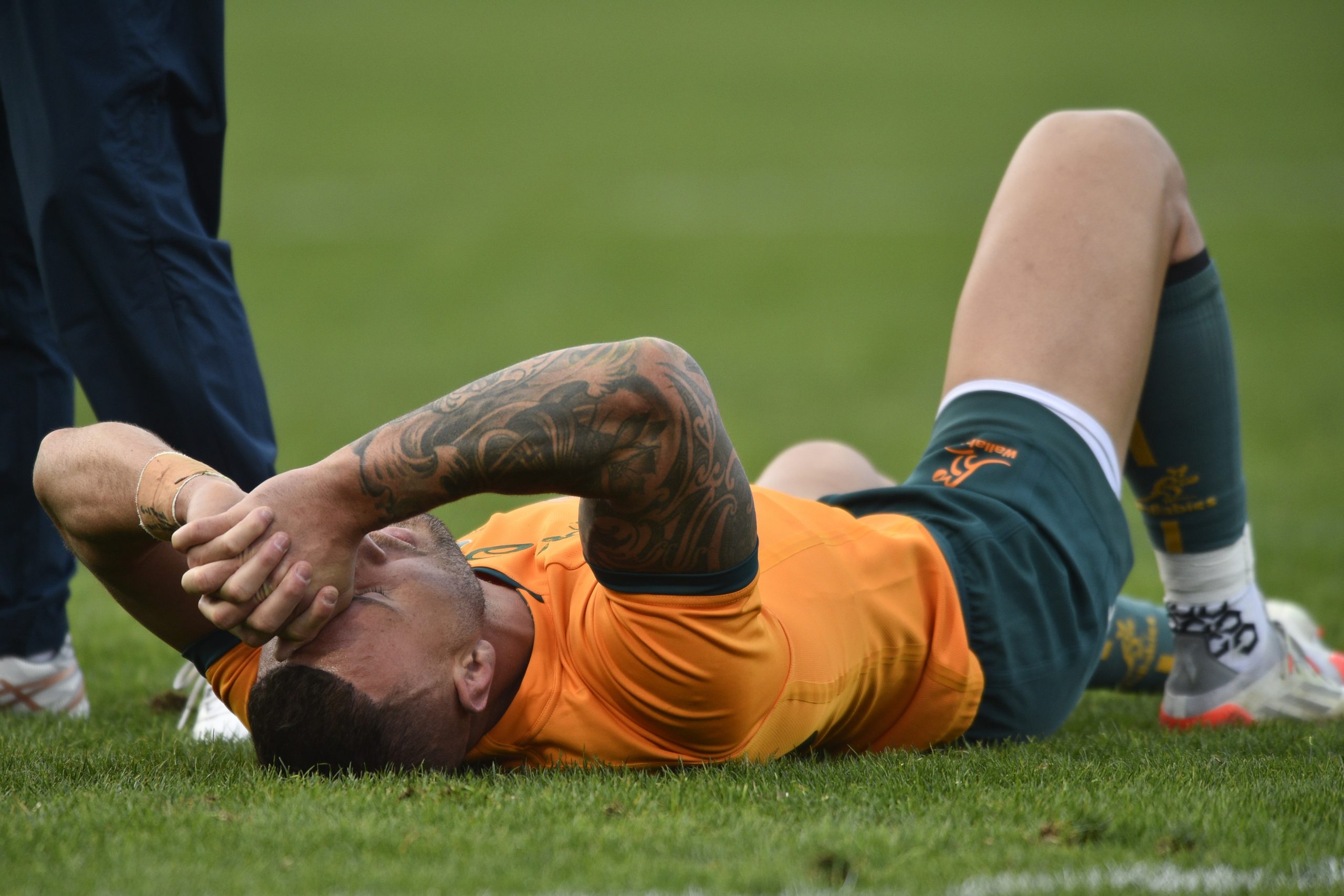 Quade Cooper lies on the pitch after rupturing his Achilles tendon prior to the Rugby Championship season-opener.