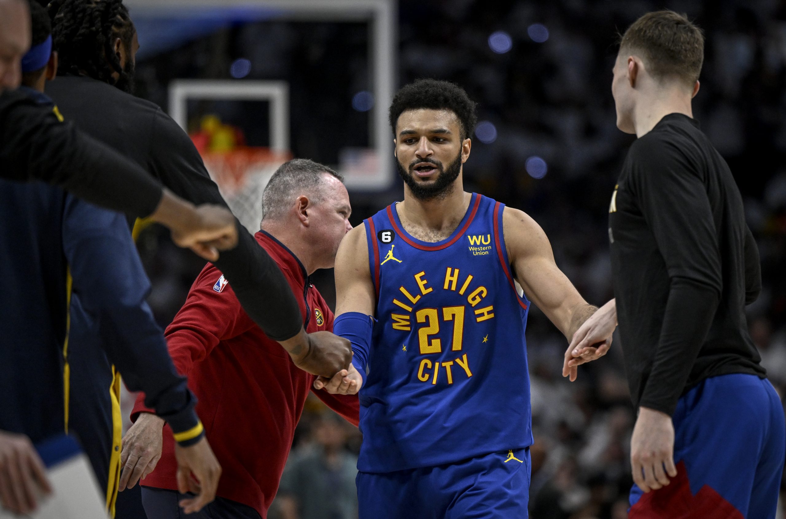 DENVER, CO - APRIL 16: Jamal Murray (27) of the Denver Nuggets high fives teammates as he heads to the bench for a timeout against the Minnesota Timberwolves during the third quarter at Ball Arena in Denver on Sunday, April 16, 2023. (Photo by AAron Ontiveroz/MediaNews Group/The Denver Post via Getty Images)