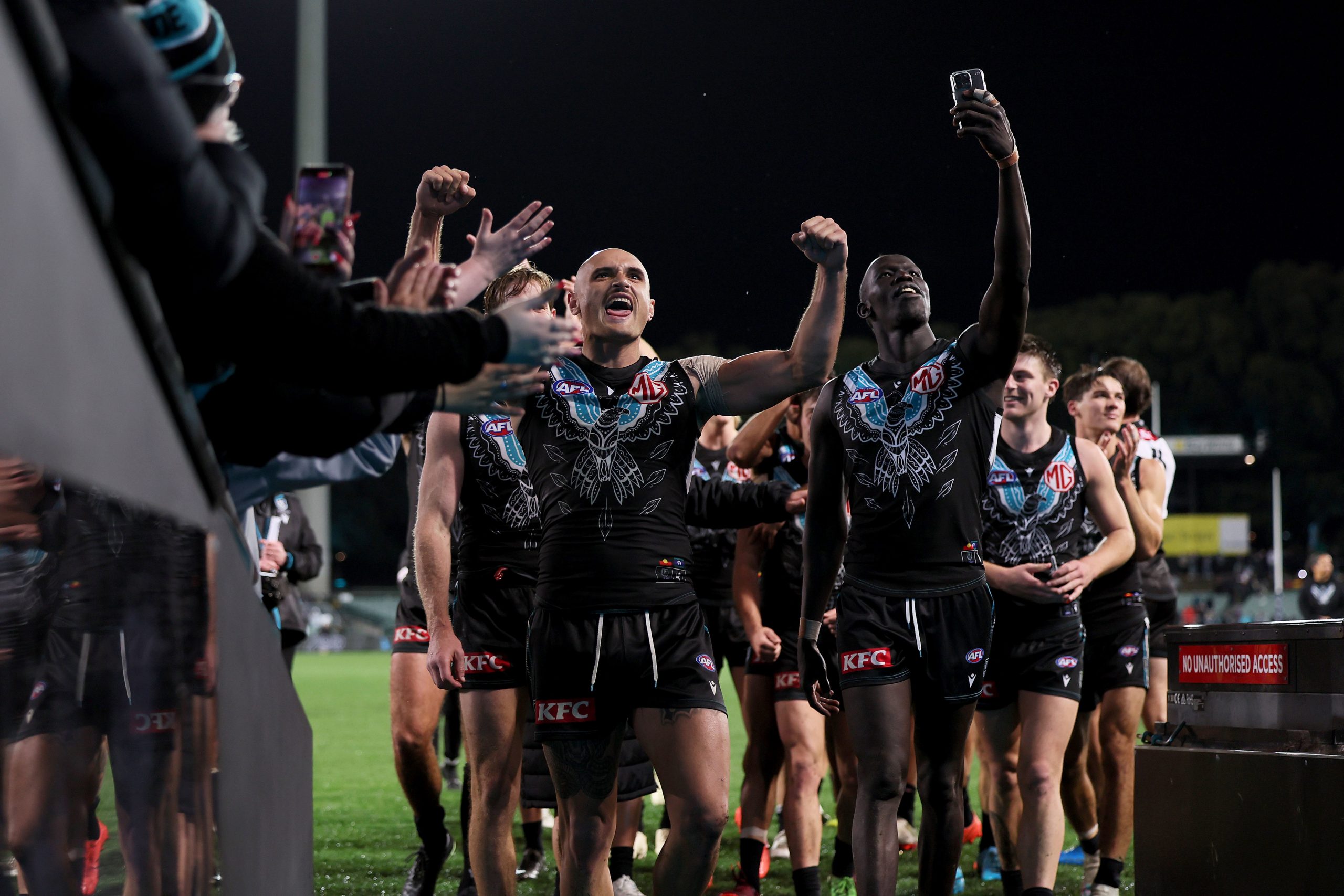 ADELAIDE, AUSTRALIA - MAY 19: Sam Powell-Pepper and Aliir Aliir of the Power celebrate they win during the 2023 AFL Round 10 match between Yartapuulti/Port Adelaide Power and Narrm/Melbourne Demons at Adelaide Oval on May 19, 2023 in Adelaide, Australia. (Photo by James Elsby/AFL Photos)