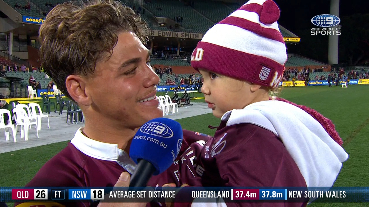 Reece Walsh holds his young daughter in his post-match interview after the Maroons defeated the Blues.
