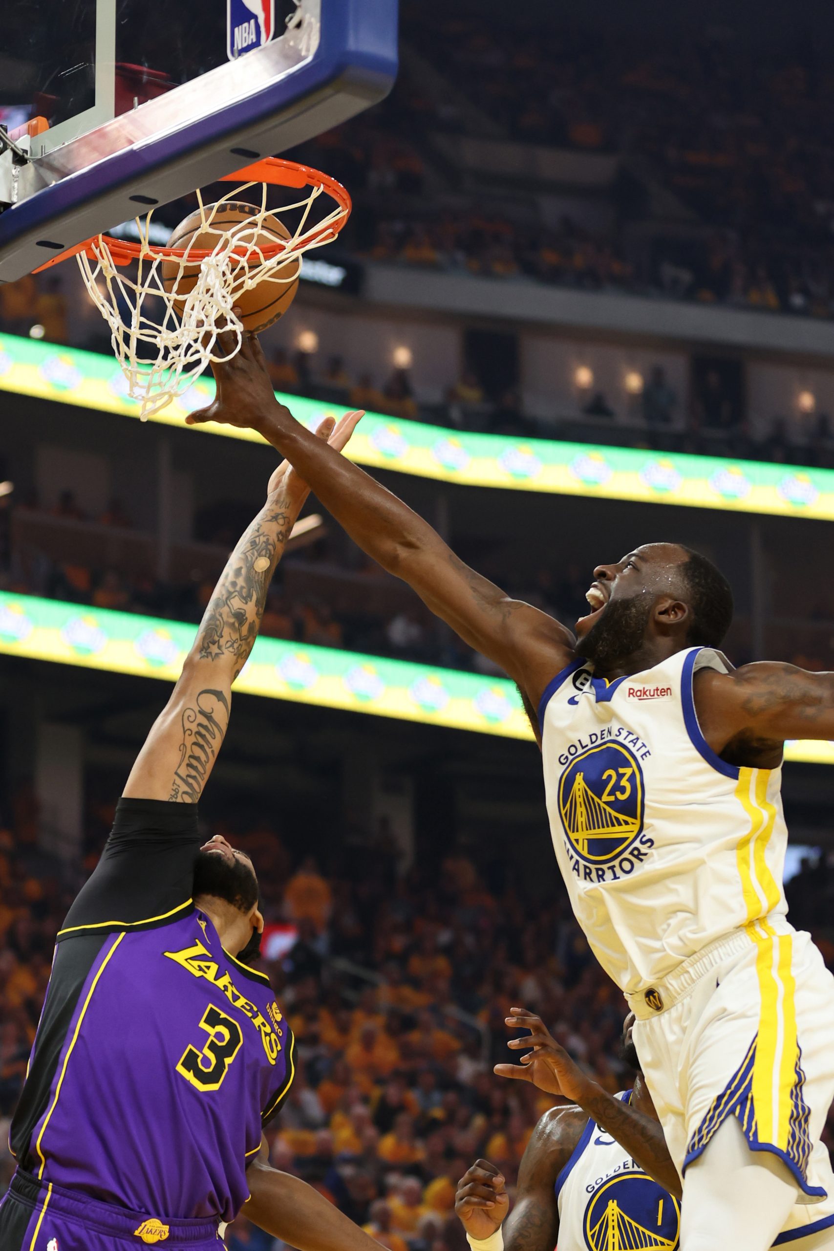 Draymond Green competes with Anthony Davis in the NBA playoffs.