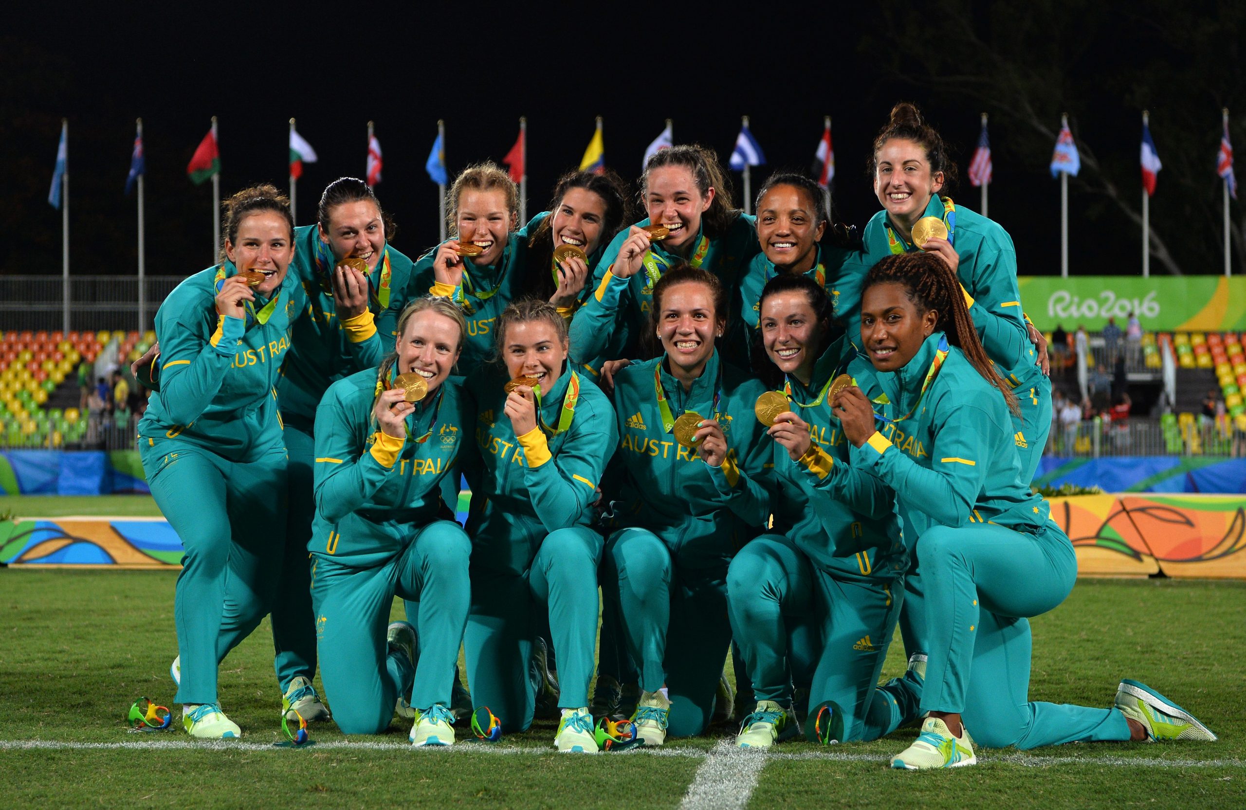 Australia pose with their gold medals following victory during the women's rugby sevens gold medal match at the the Rio 2016 Olympic Games.
