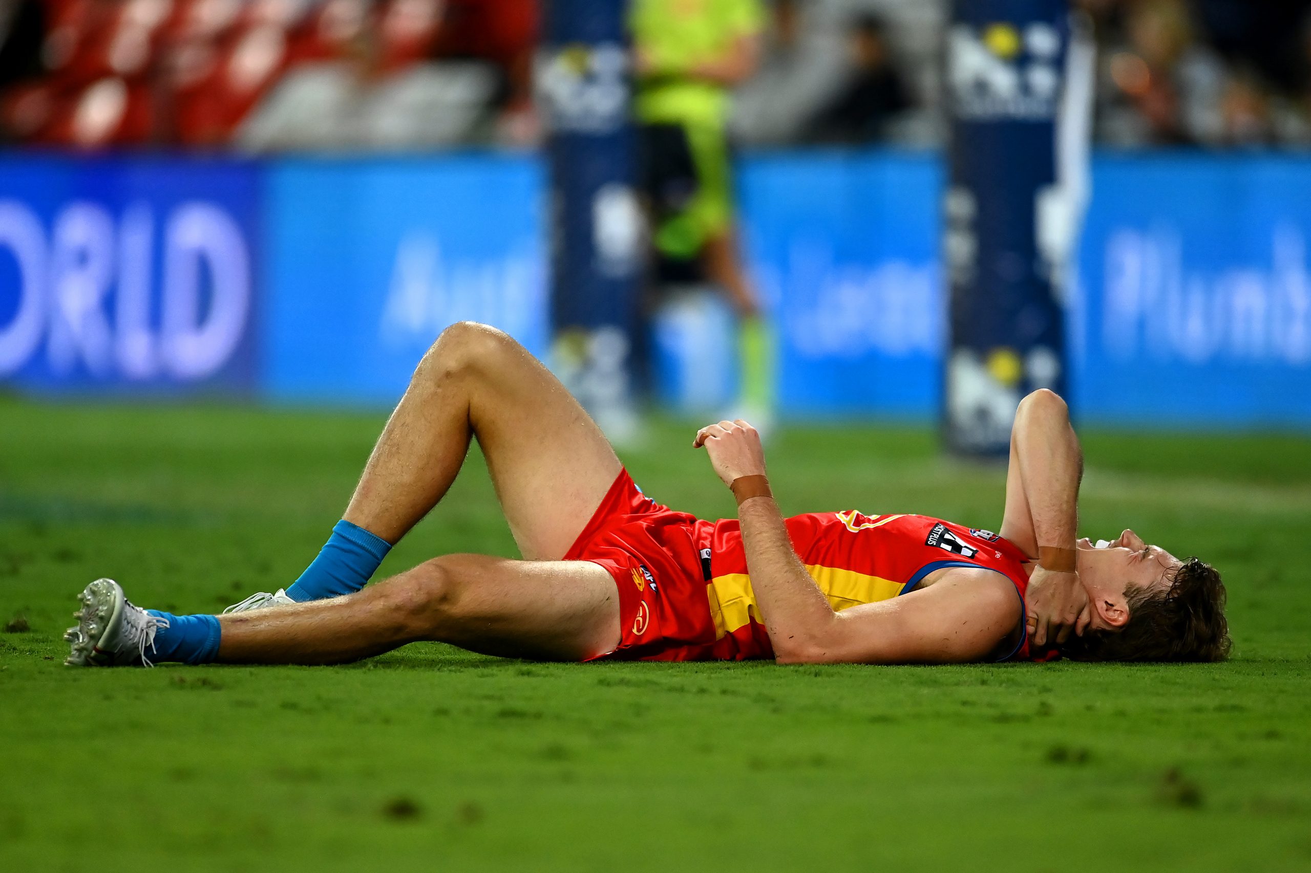 GOLD COAST, AUSTRALIA - MAY 06: Charlie Ballard of the Suns suffers an injury while challenging for the ball against Jacob van Rooyen of the Demons  during the round eight AFL match between the Gold Coast Suns and the Melbourne Demons at Heritage Bank Stadium, on May 06, 2023, in Gold Coast, Australia. (Photo by Albert Perez/AFL Photos via Getty Images)