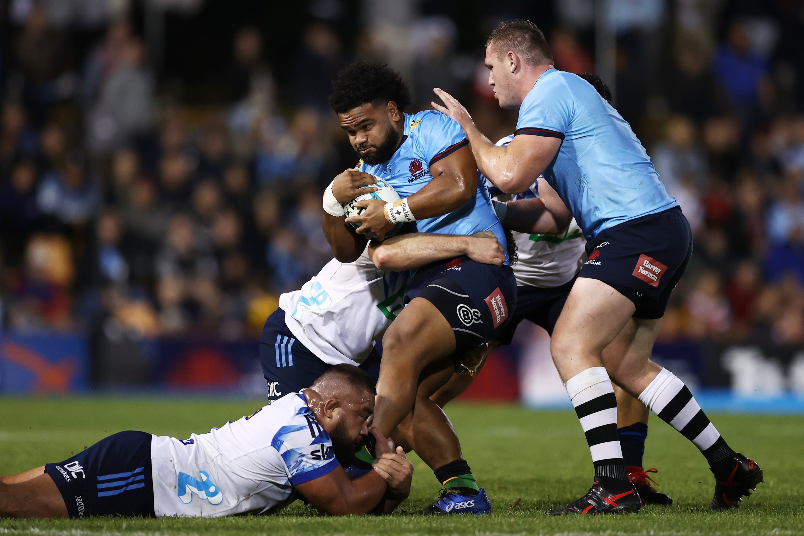 Mahe Vailanu of the Waratahs is tackled during the round 15 Super Rugby Pacific match between the NSW Waratahs and the Blues at Leichhardt Oval.