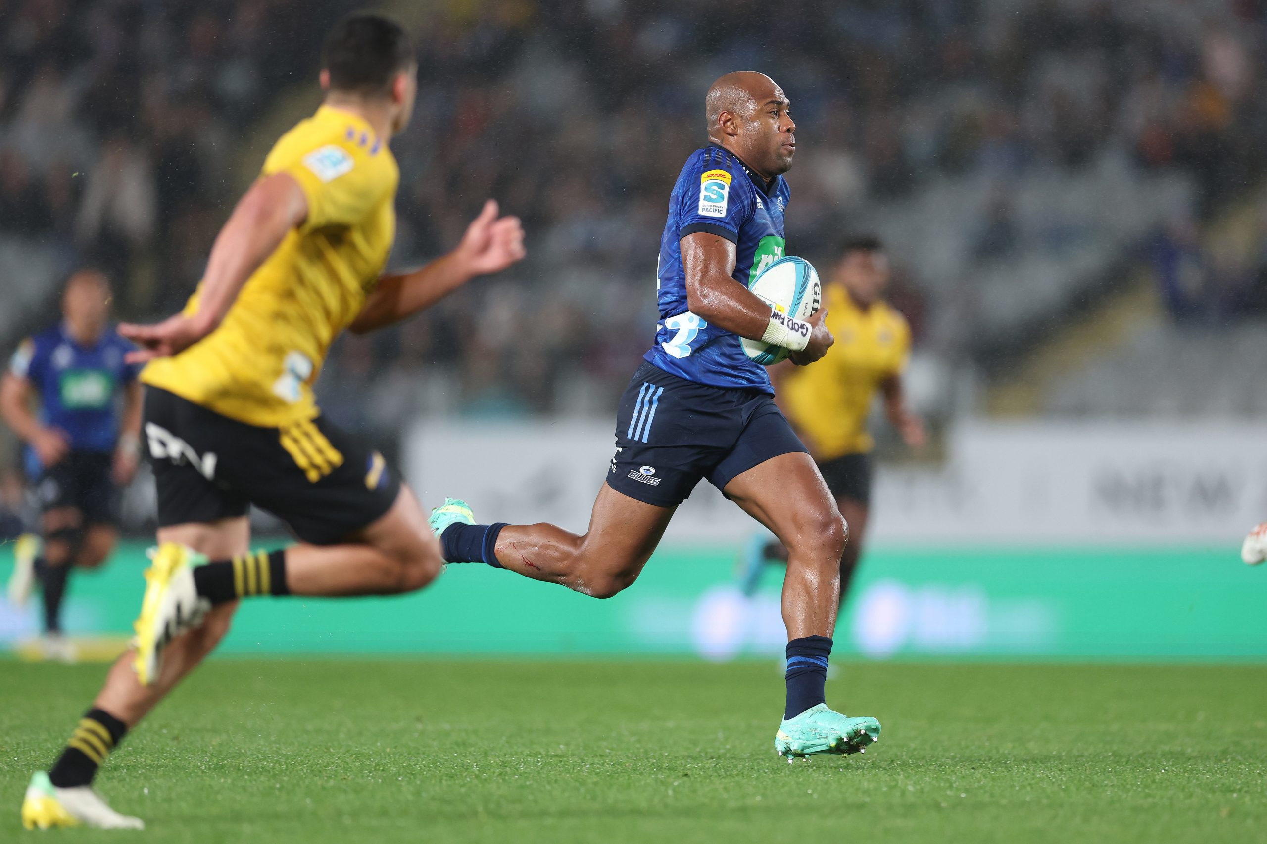 Mark Telea runs from the Hurricanes defence to score another try.