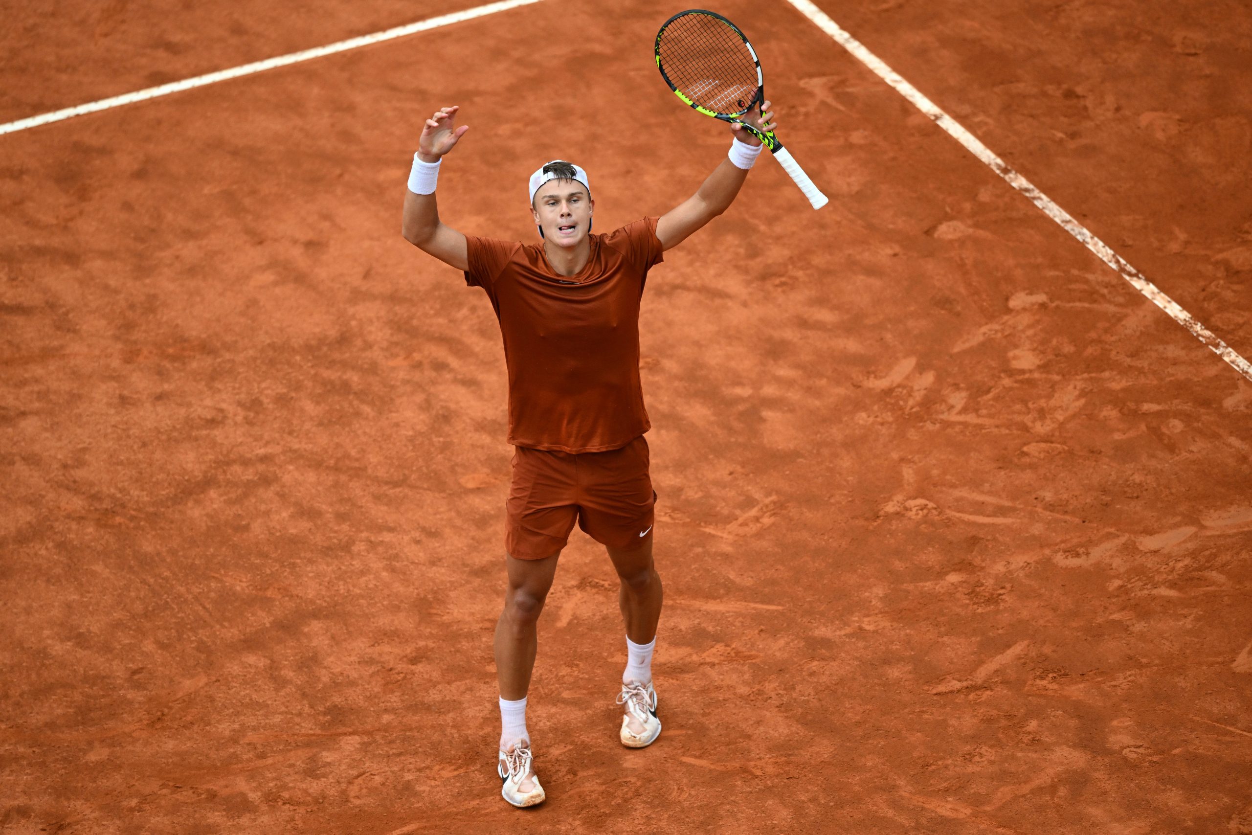 Holger Rune of Denmark celebrates a point against Novak Djokovic of Serbia.