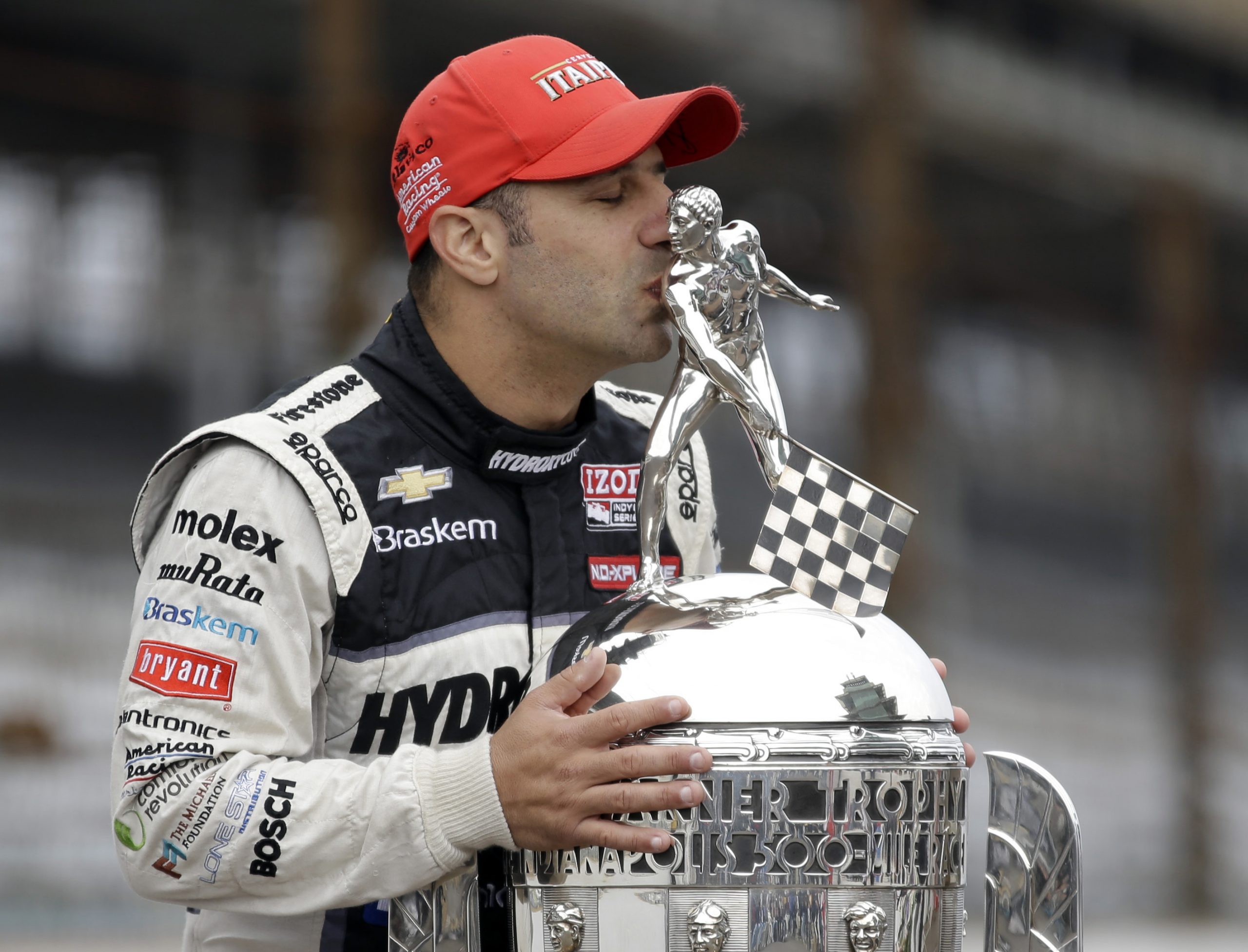 Tony Kanaan kisses the Borg-Warner Trophy after winning the 2013 Indianapolis 500 for KV Racing.