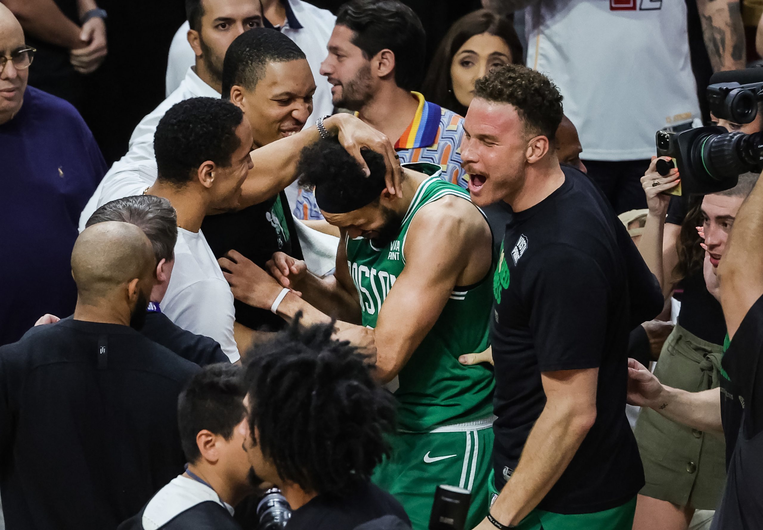 Derrick White and teammates react after defeating the Miami Heat.