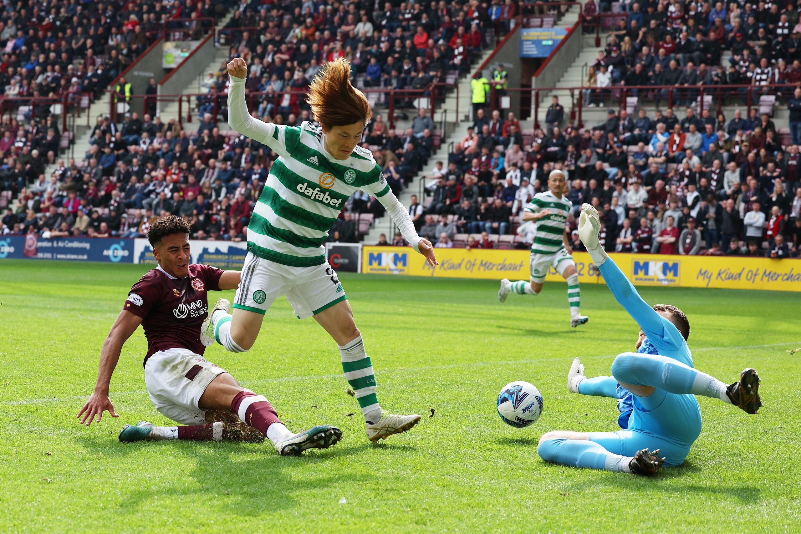 Kyogo Furuhashi of Celtic scores the team's first goal past Zander Clark of Heart of Midlothian during the Cinch Scottish Premiership match between Heart of Midlothian and Celtic FC at Tynecastle Park on May 07, 2023 in Edinburgh, Scotland. (Photo by Ian MacNicol/Getty Images)