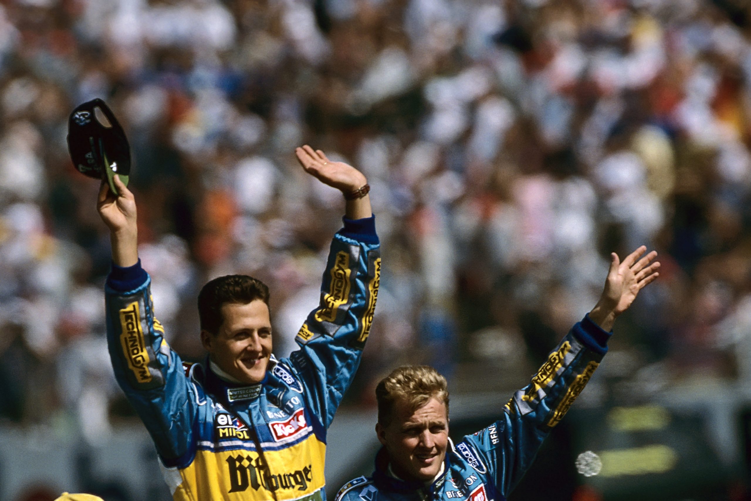 Michael Schumacher, Johnny Herbert, Grand Prix of Germany, Hockenheimring, 30 July 1995. Michael Schumacher and teammate Johnny Herbert on a parade lap before the 1995 German Grand Prix. (Photo by Paul-Henri Cahier /Getty Images)