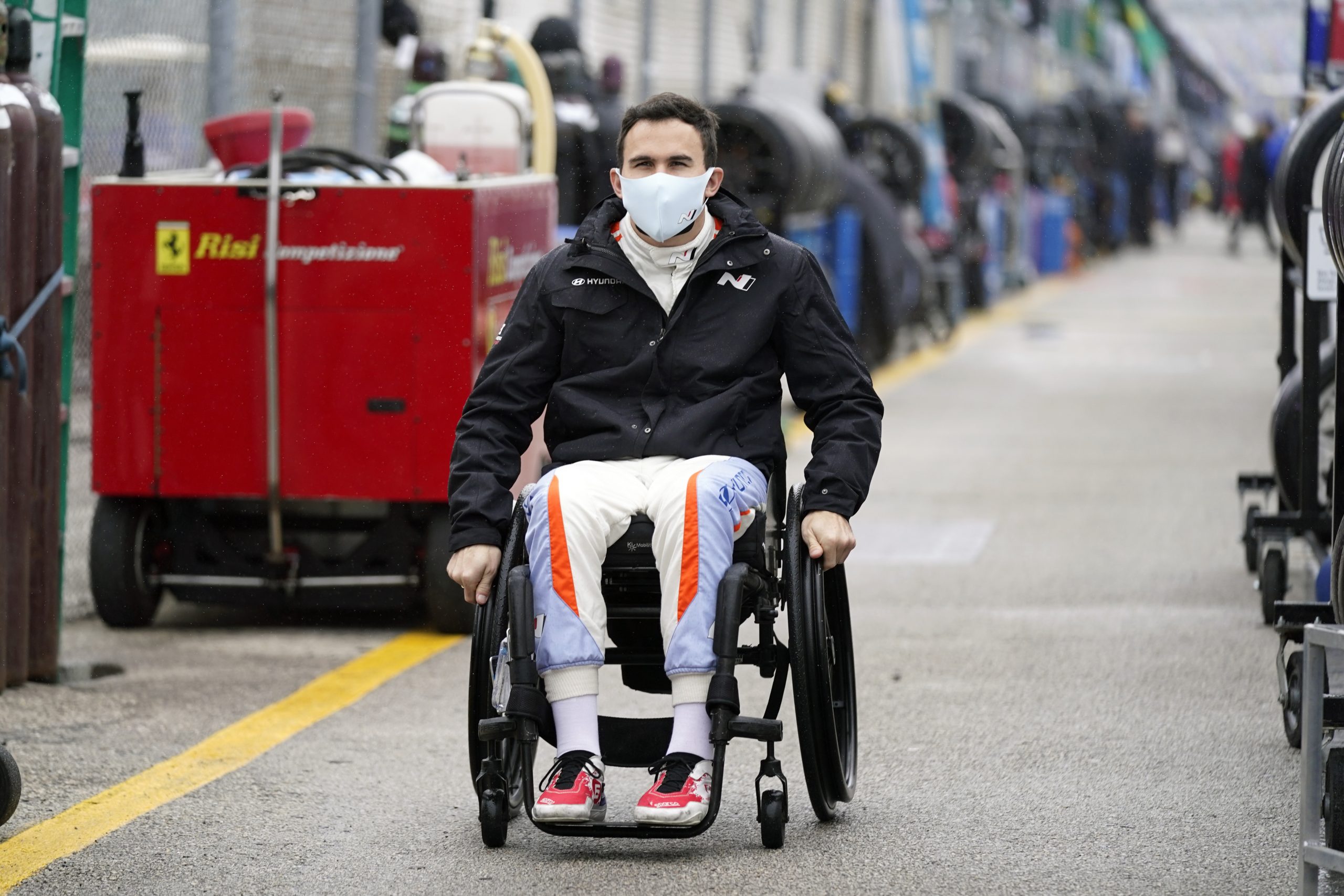 Robert Wickens makes his way to his pit stall during practice for the 24-hour auto race at Daytona International Speedway.