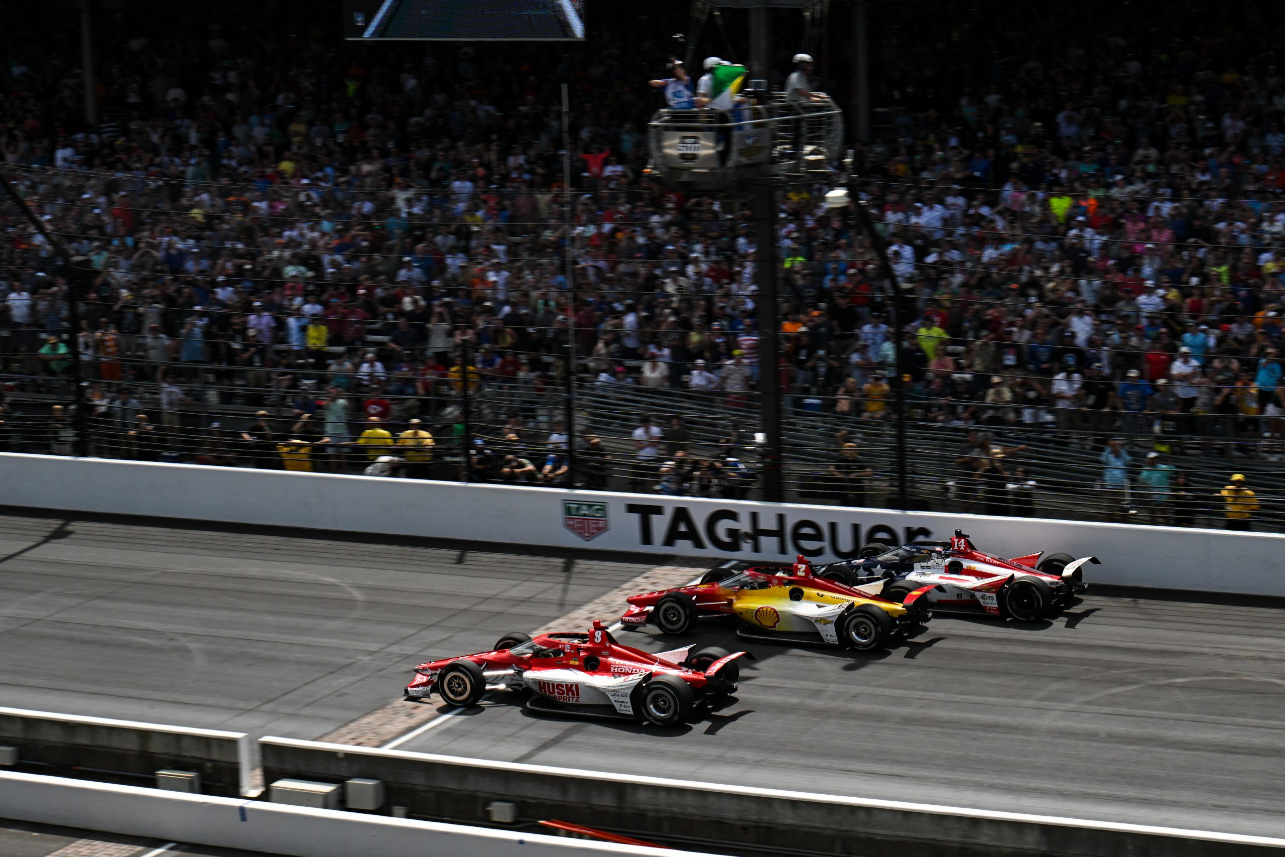 Marcus Ericsson leads Josef Newgarden and Santino Ferrucci across the line on the final restart of the 107th Indianapolis 500. 