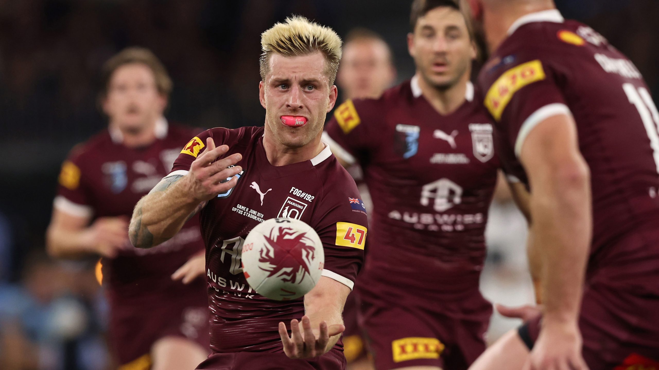 Cameron Munster passes the ball to a Maroons teammate in State of Origin 2022.