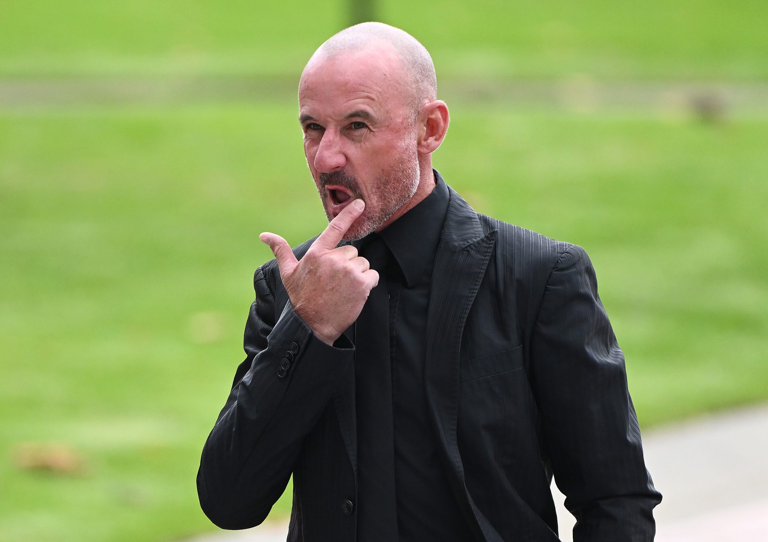 Top jockey Glen Boss arrives for Dean Holland's funeral at Flemington Racecourse.