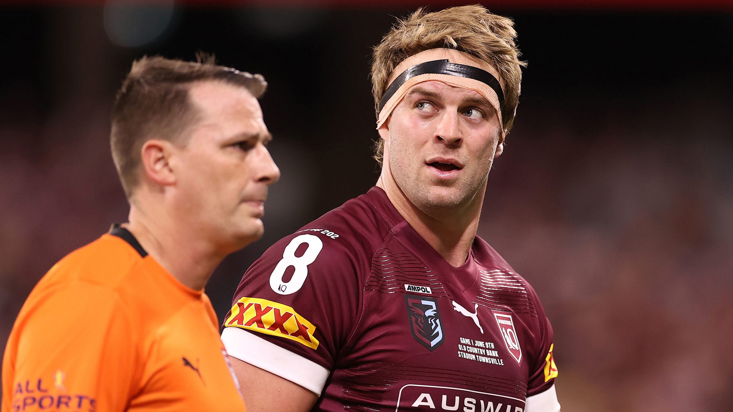 Christian Welch of the Maroons is attended to by a team trainer after a tackle during game one of the 2021 State of Origin series between the New South Wales Blues and the Queensland Maroons at Queensland Country Bank Stadium on June 09, 2021 in Townsville, Australia. 