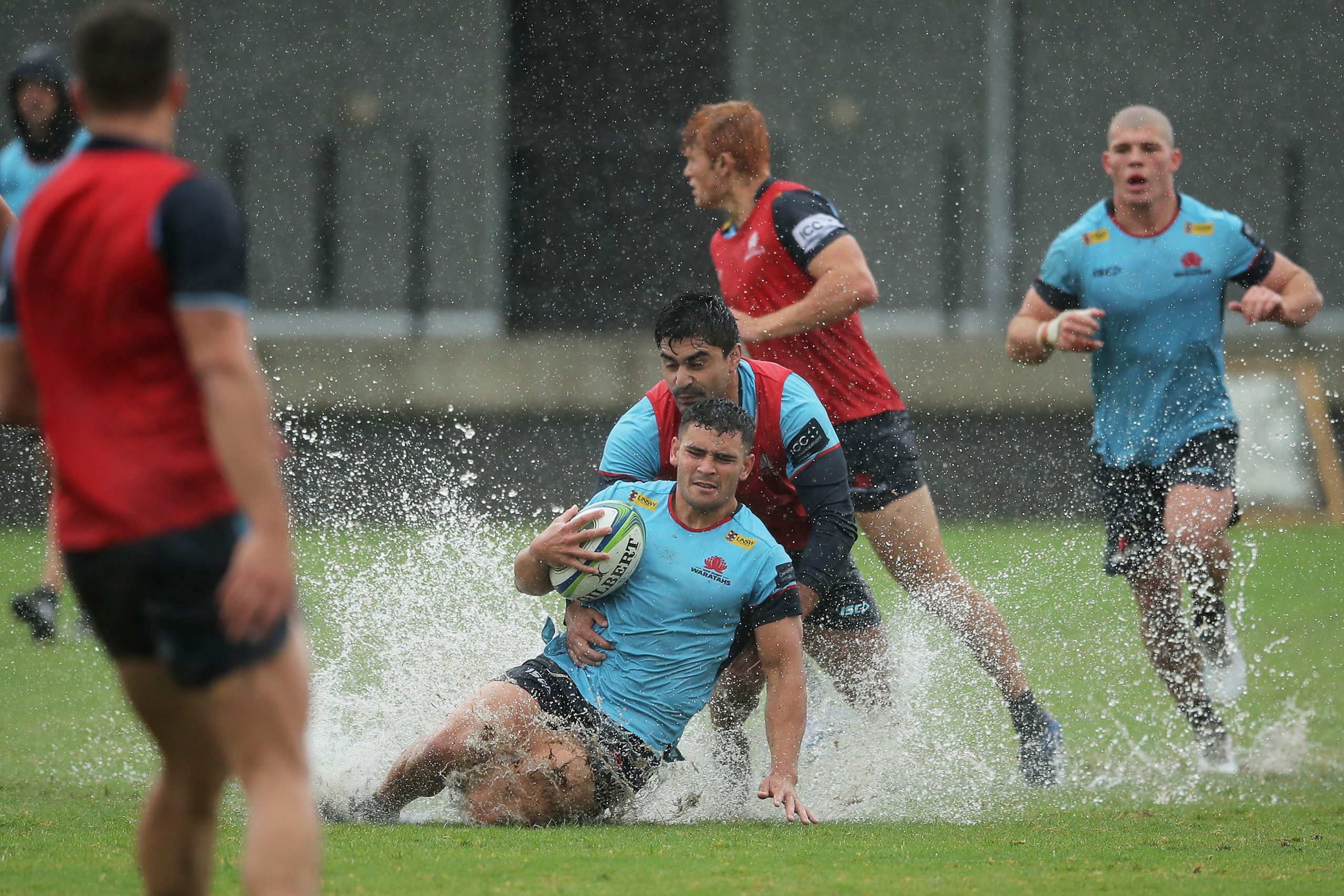 Izaia Perese is tackled during a NSW Waratahs training session in Sydney.