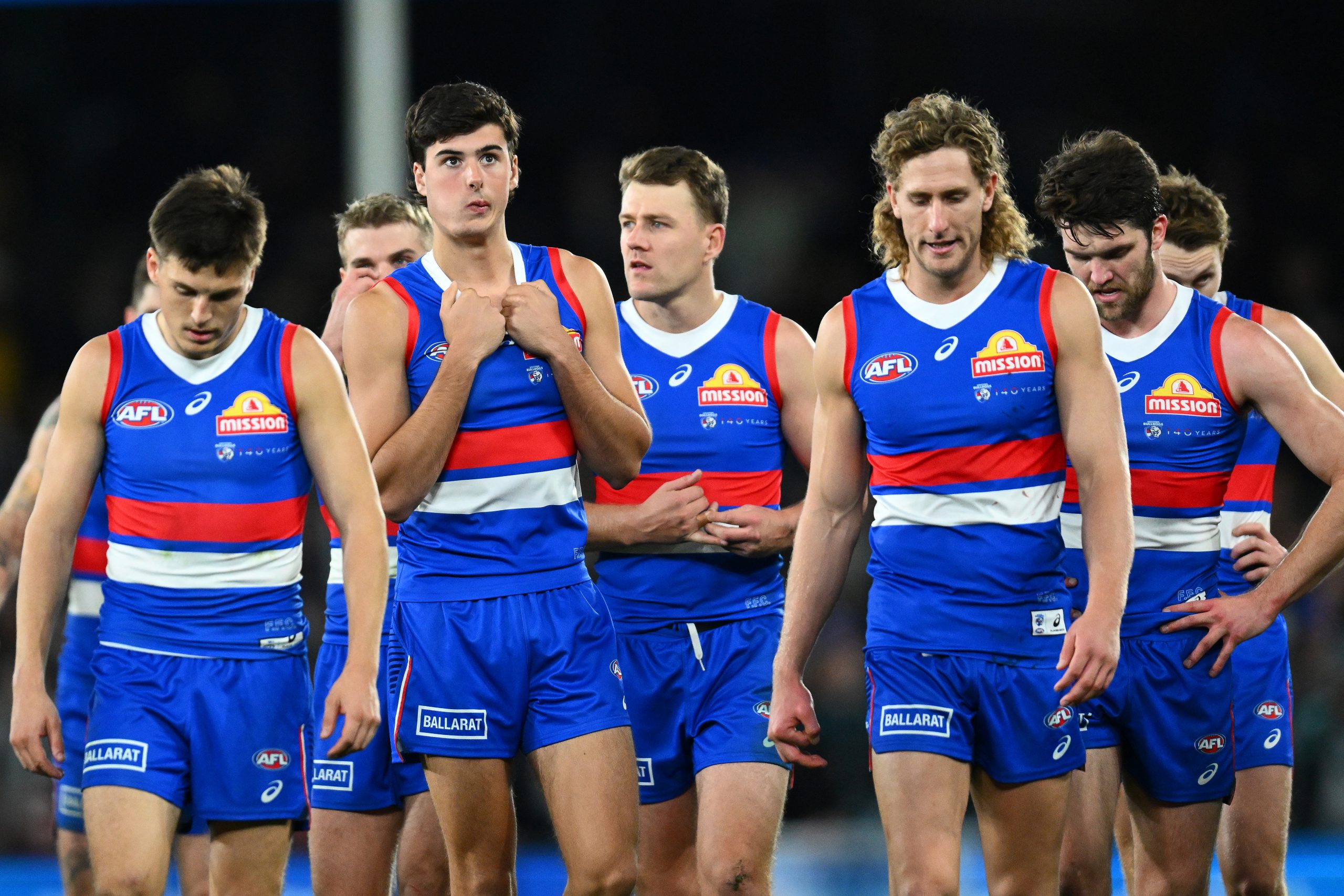 The Bulldogs look dejected after losing the round 13 AFL match between Western Bulldogs and Port Adelaide Power at Marvel Stadium, on June 09, 2023, in Melbourne, Australia. (Photo by Quinn Rooney/Getty Images)