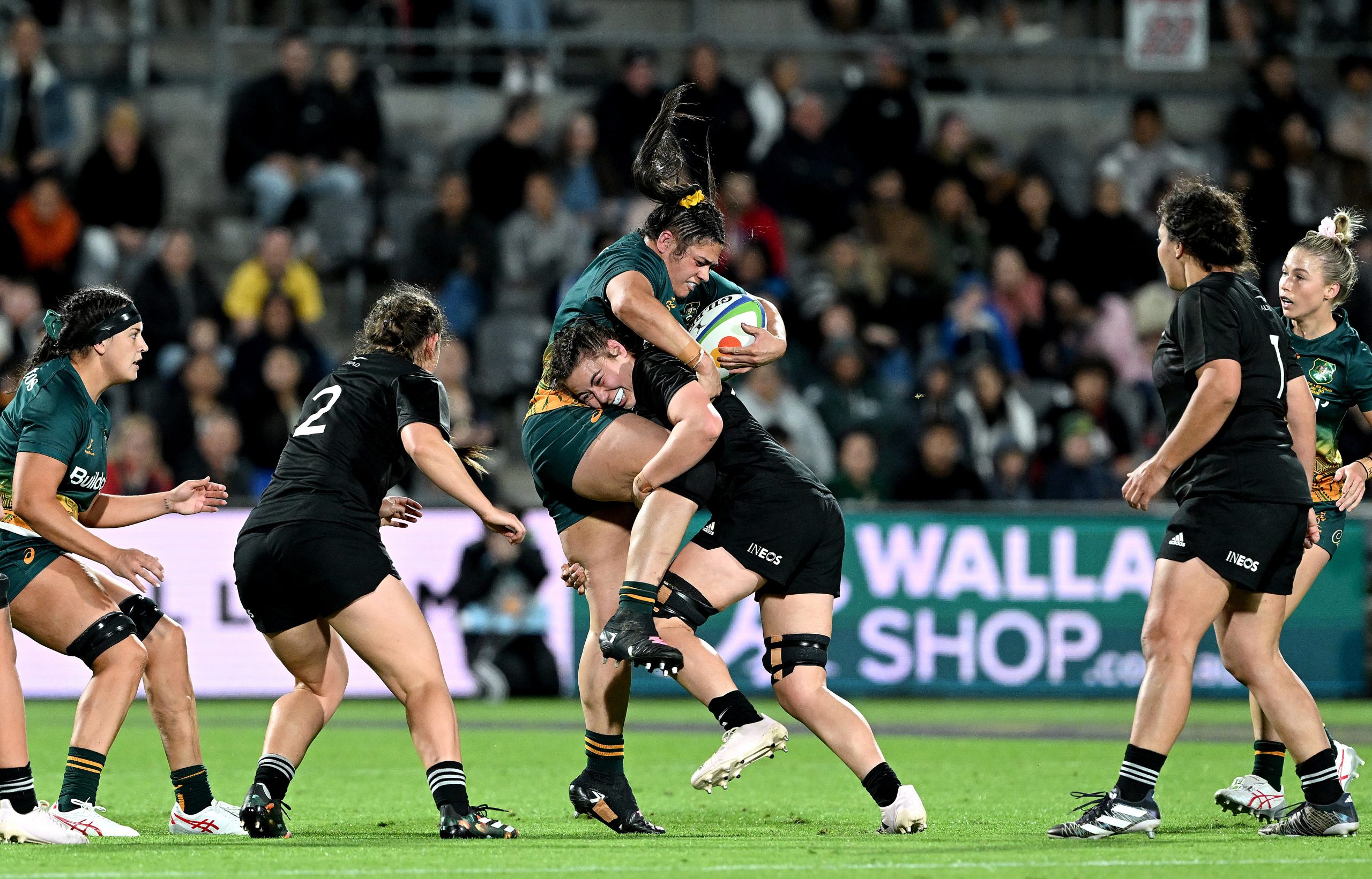 Eva Karpani of Australia is tackled by Maiakawanakaulani Roos of New Zealand.