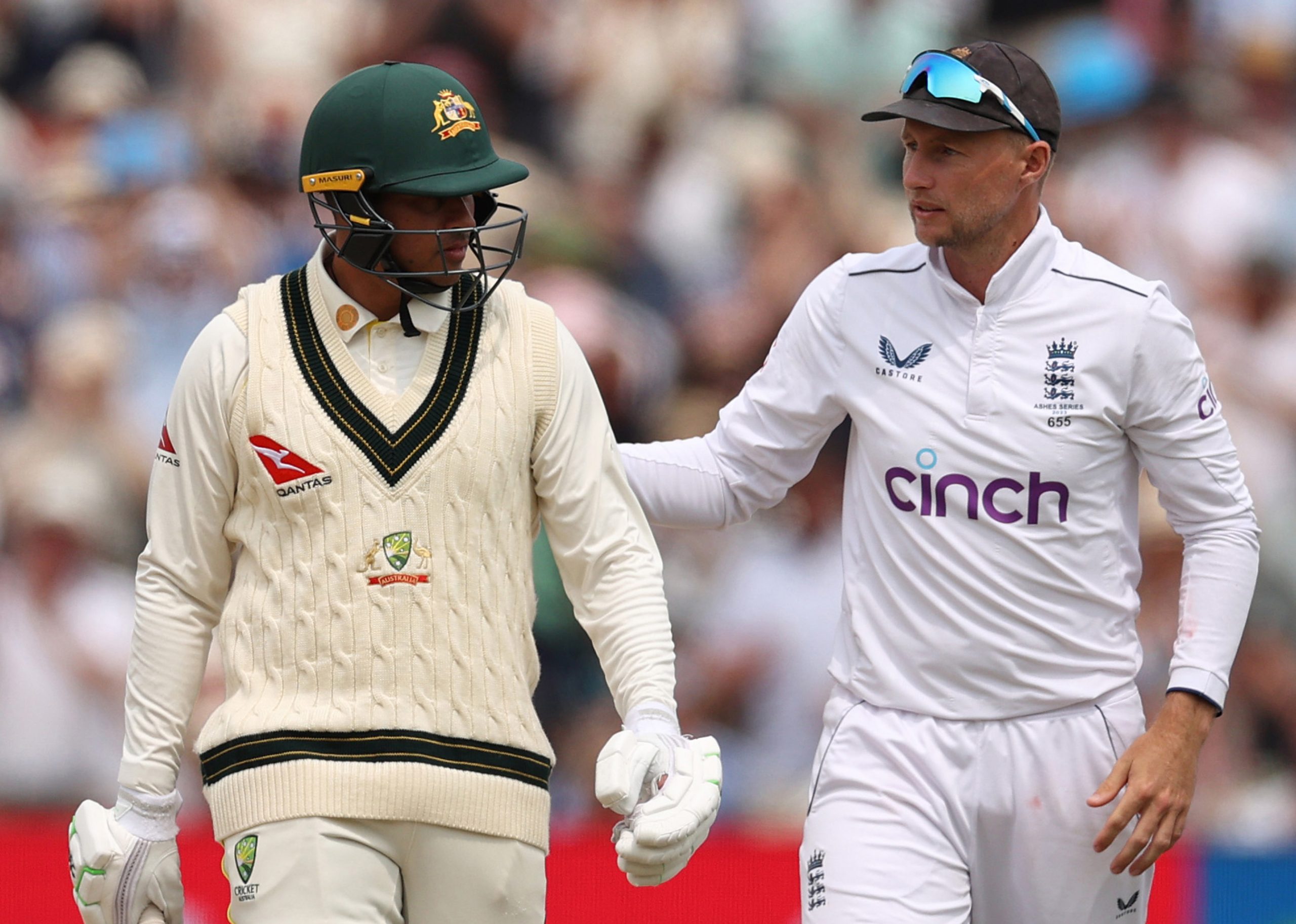 Usman Khawaja of Australia is embraced by Joe Root of England as he walks off after being bowled by Ollie Robinson.