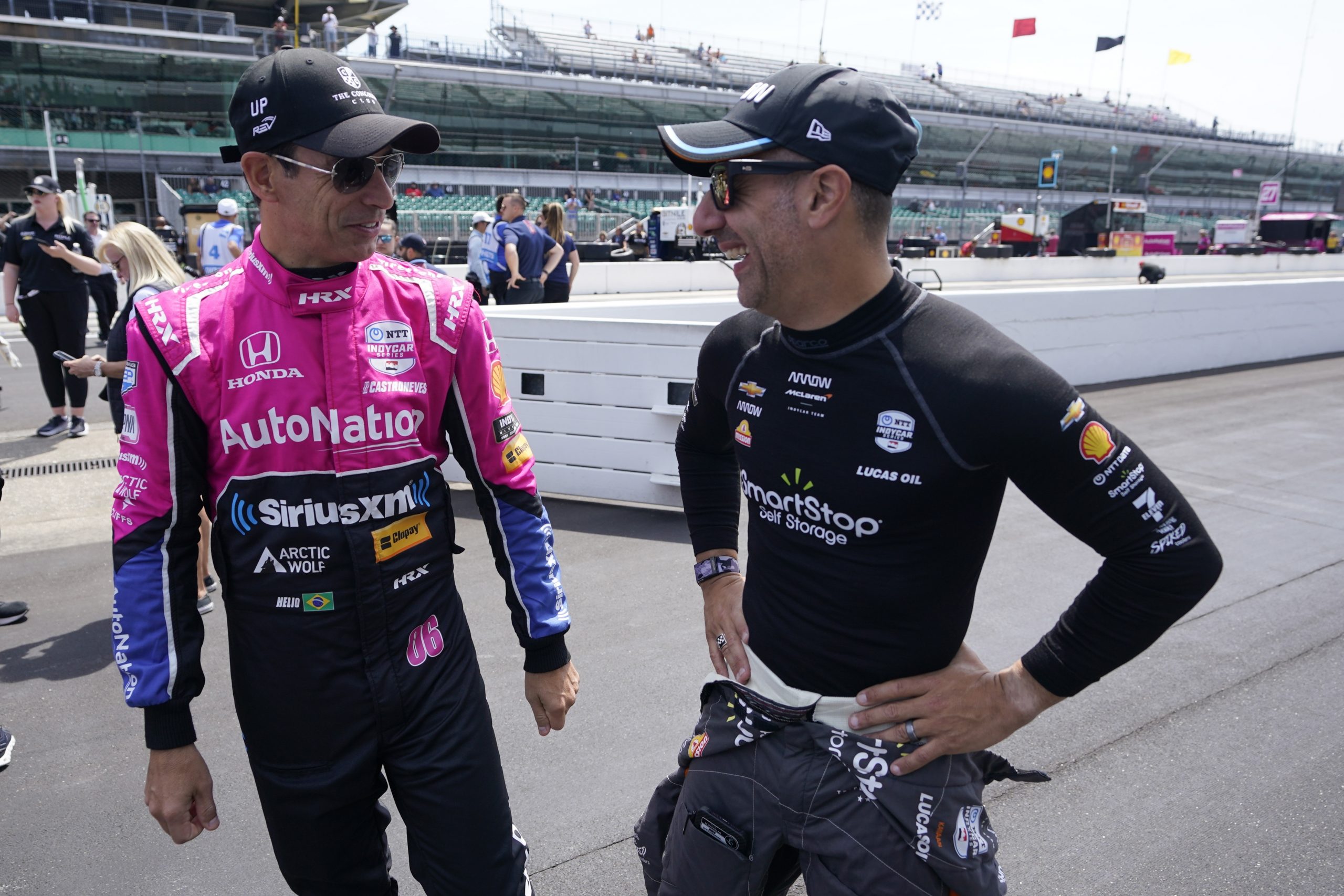 Helio Castroneves (left) and Tony Kanaan chat before practice for the Indianapolis 500.