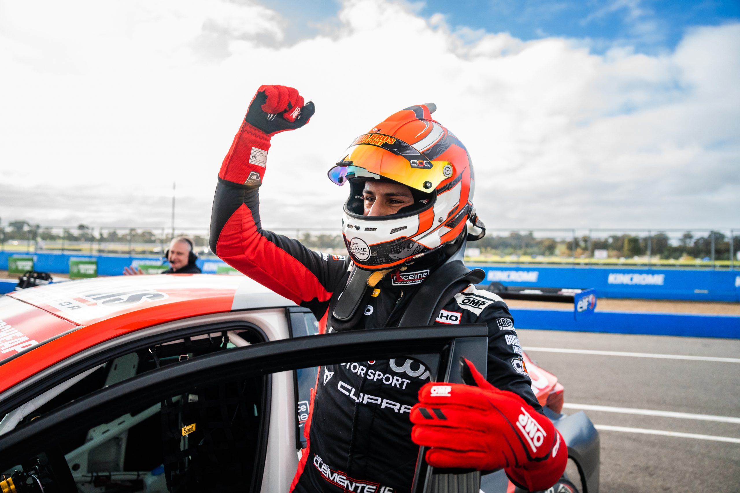 Michael Clemente celebrates next to his Cupra.