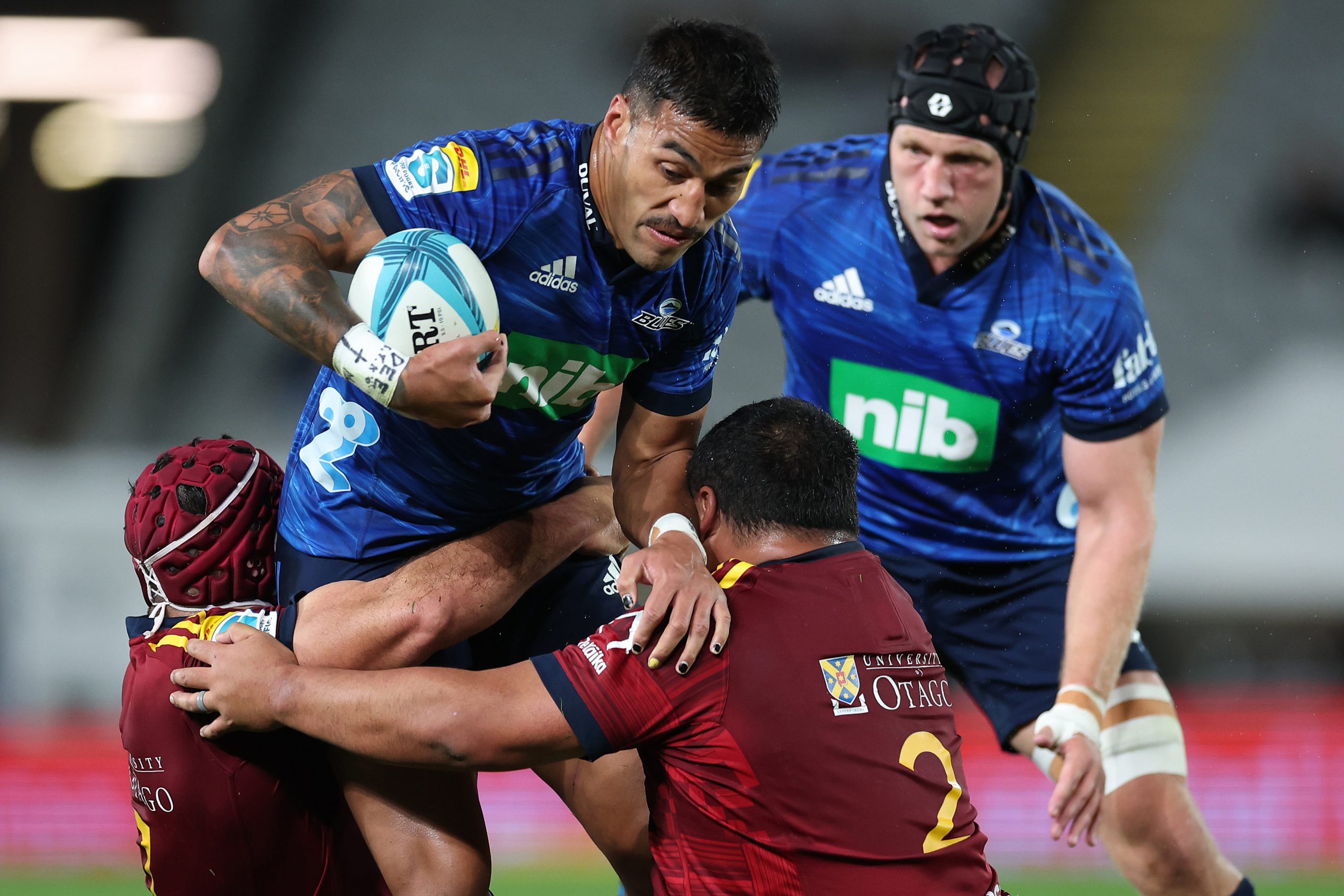 Rieko Ioane of the Blues is tackled.