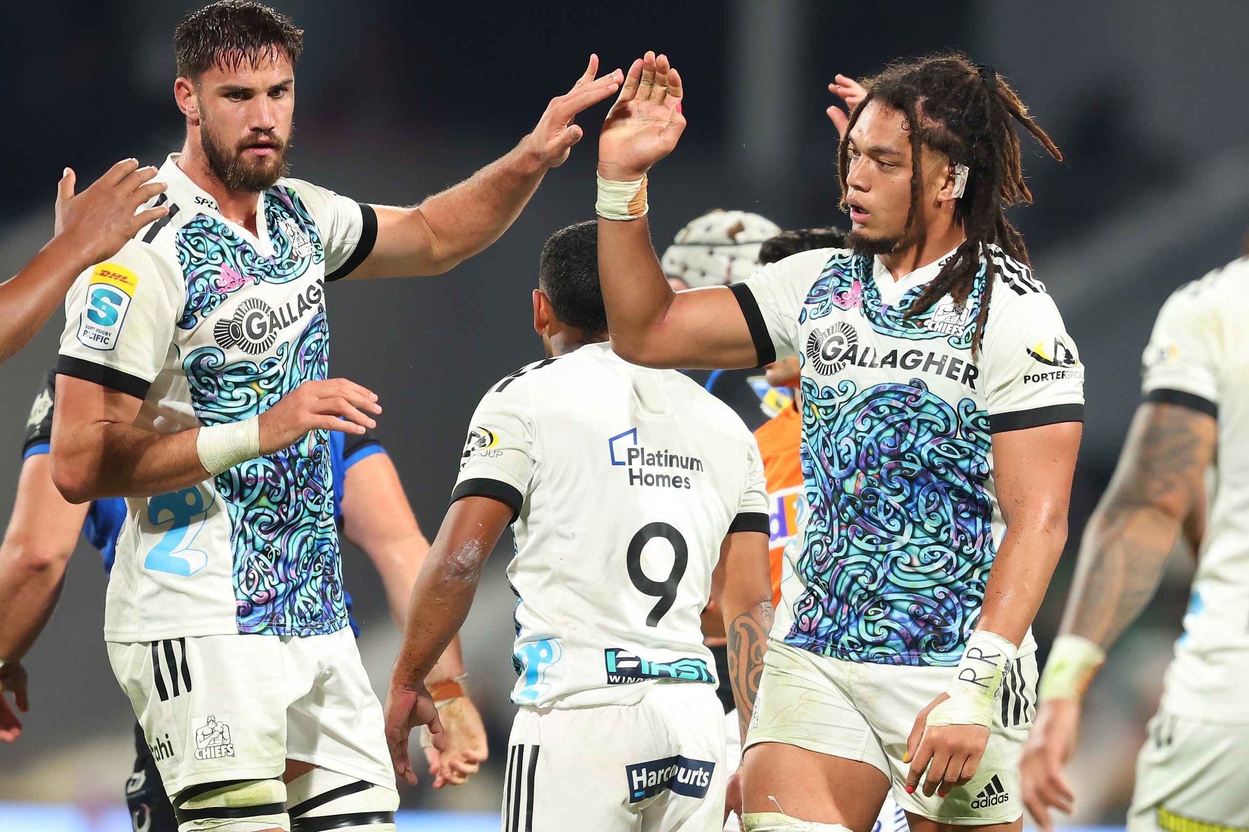 Naitoa Ah Kuoi of the Chiefs high fives his team mate.