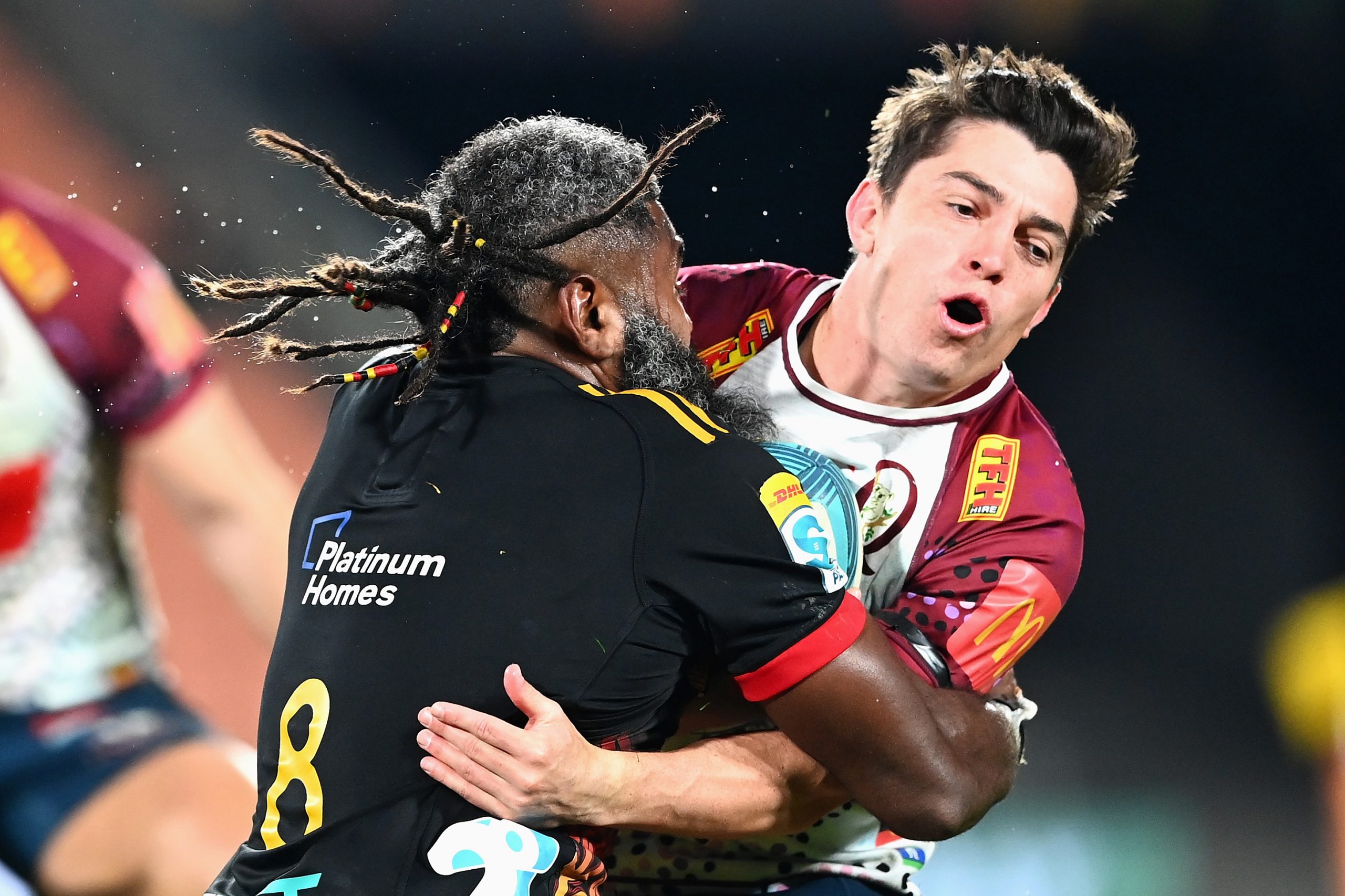 Jock Campbell of the Reds is tackled by Pita Gus Sowakula of the Chiefs.