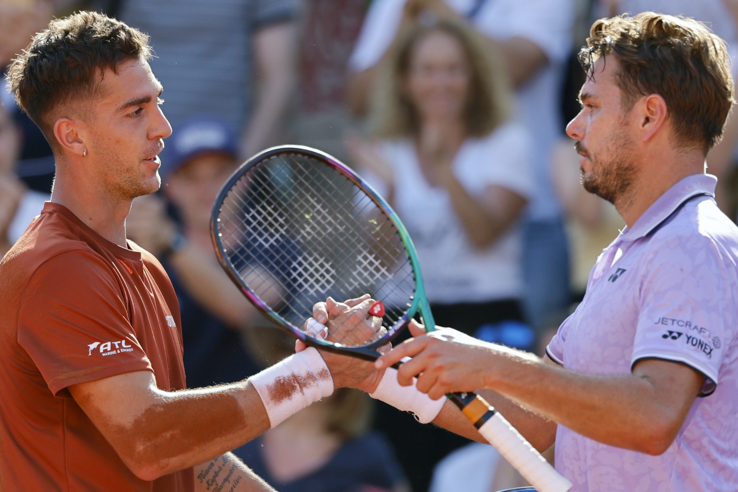 Thanasi Kokkinakis (left) and Stan Wawrinka shake hands after their second round match.