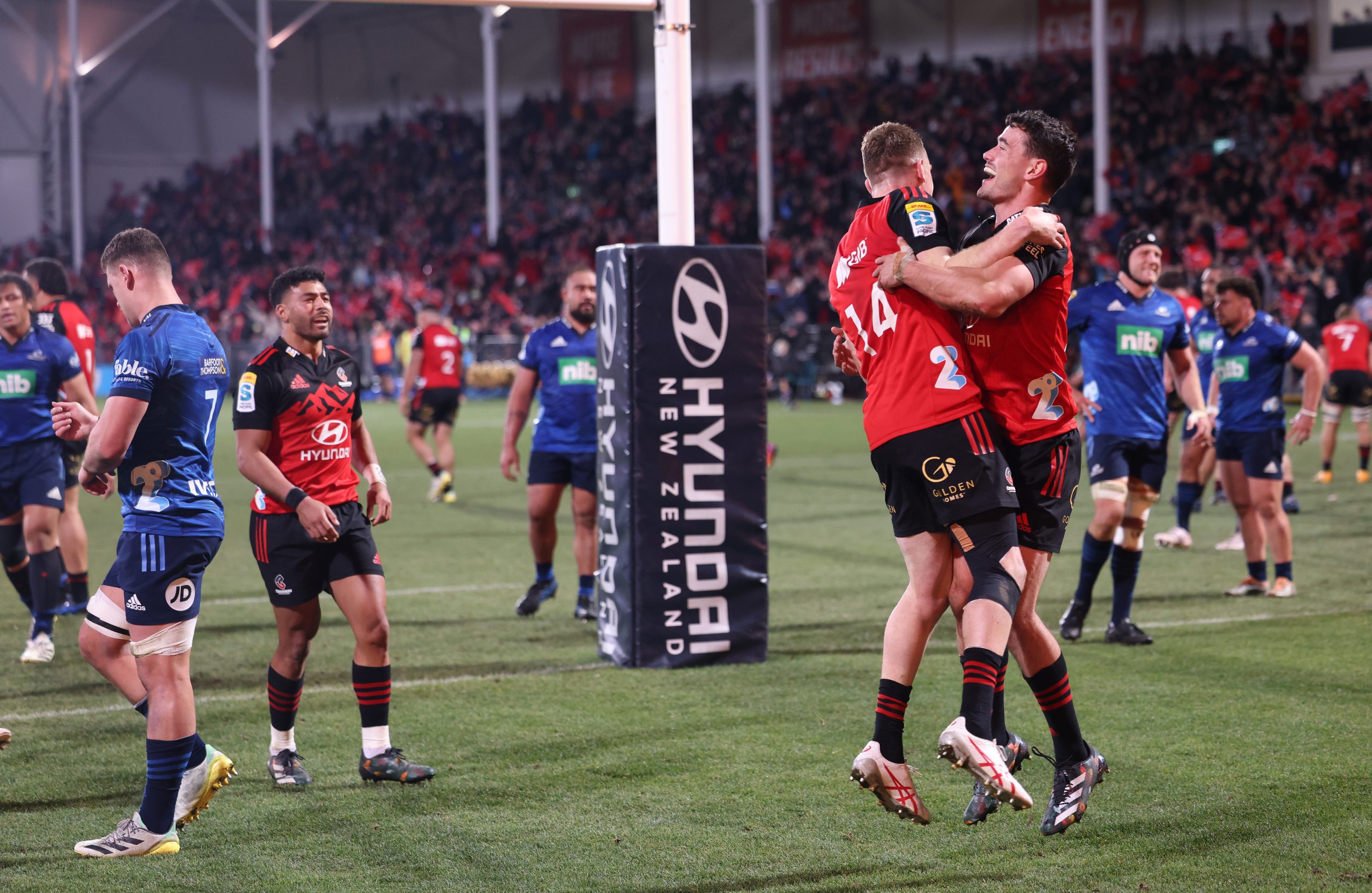 Dallas McLeod and Will Jordan of the Crusaders celebrate a try during the Super Rugby Pacific semi final.