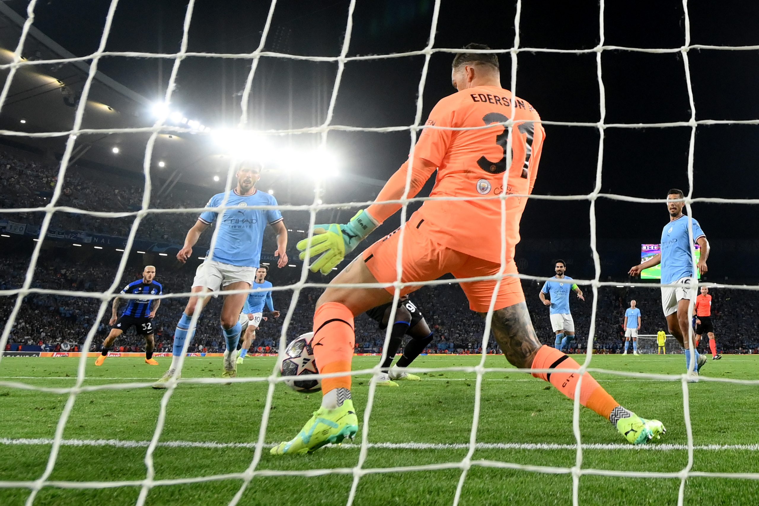 Manchester City goalkeeper Ederson makes a crucial save.