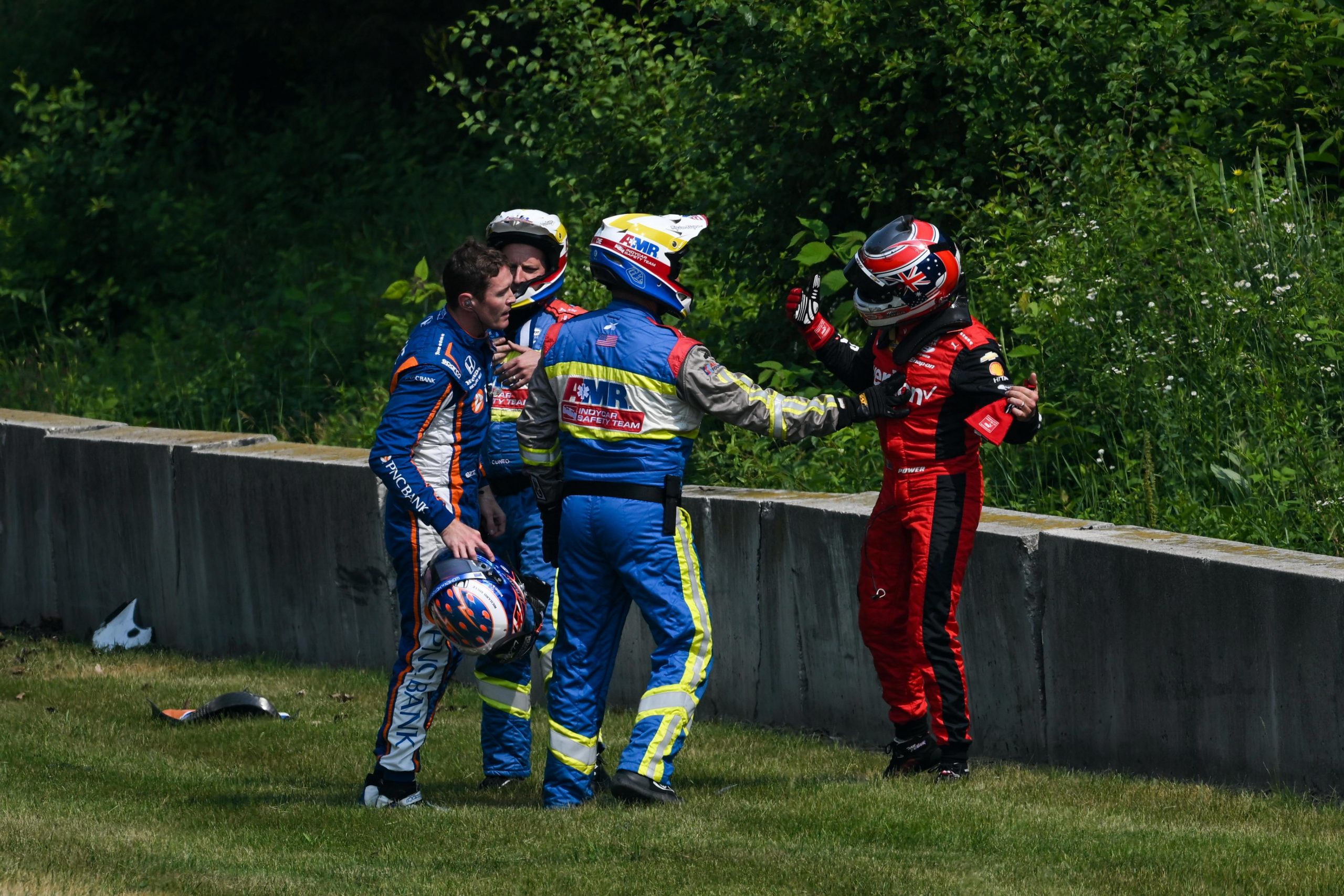 Will Power (right) confronts Scott Dixon after crashing in practice.