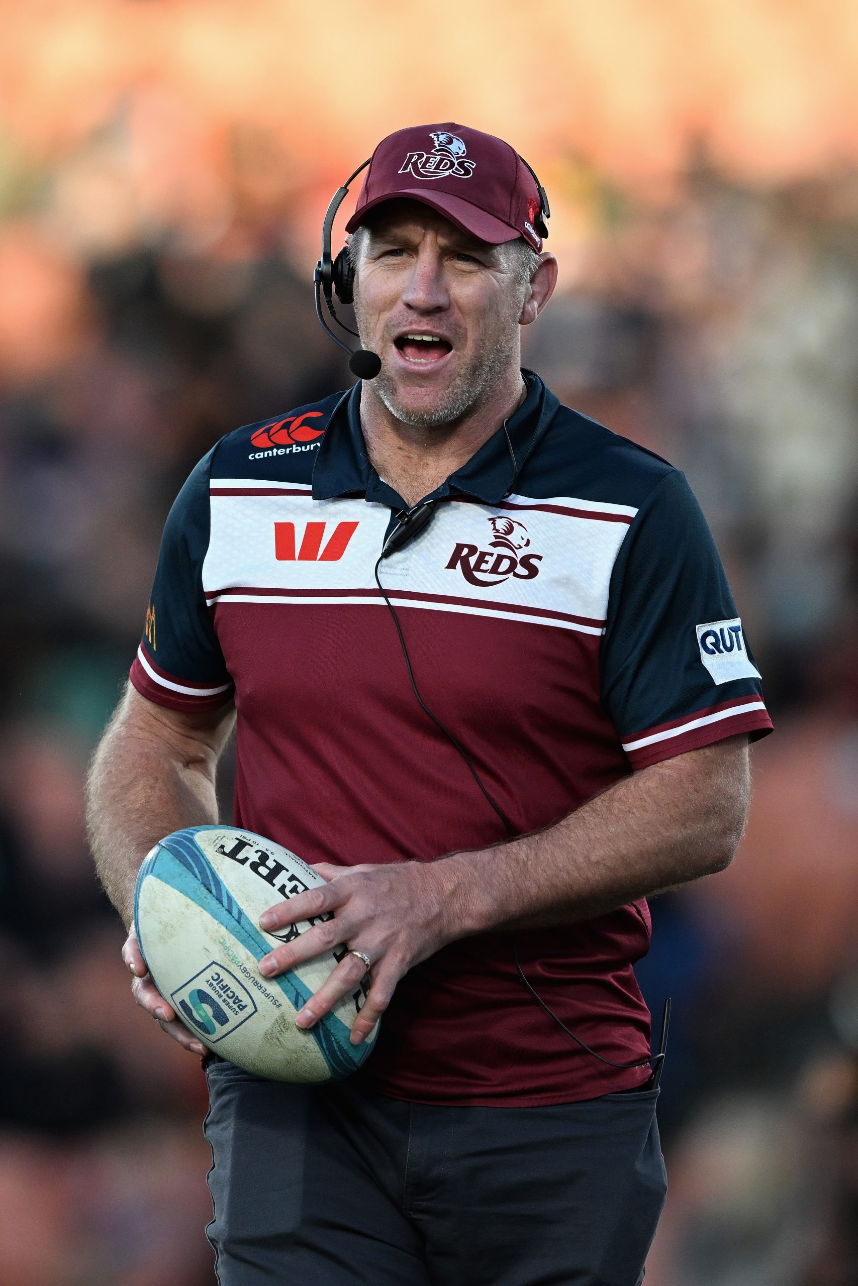 Reds coach Brad Thorn watches players warm up.