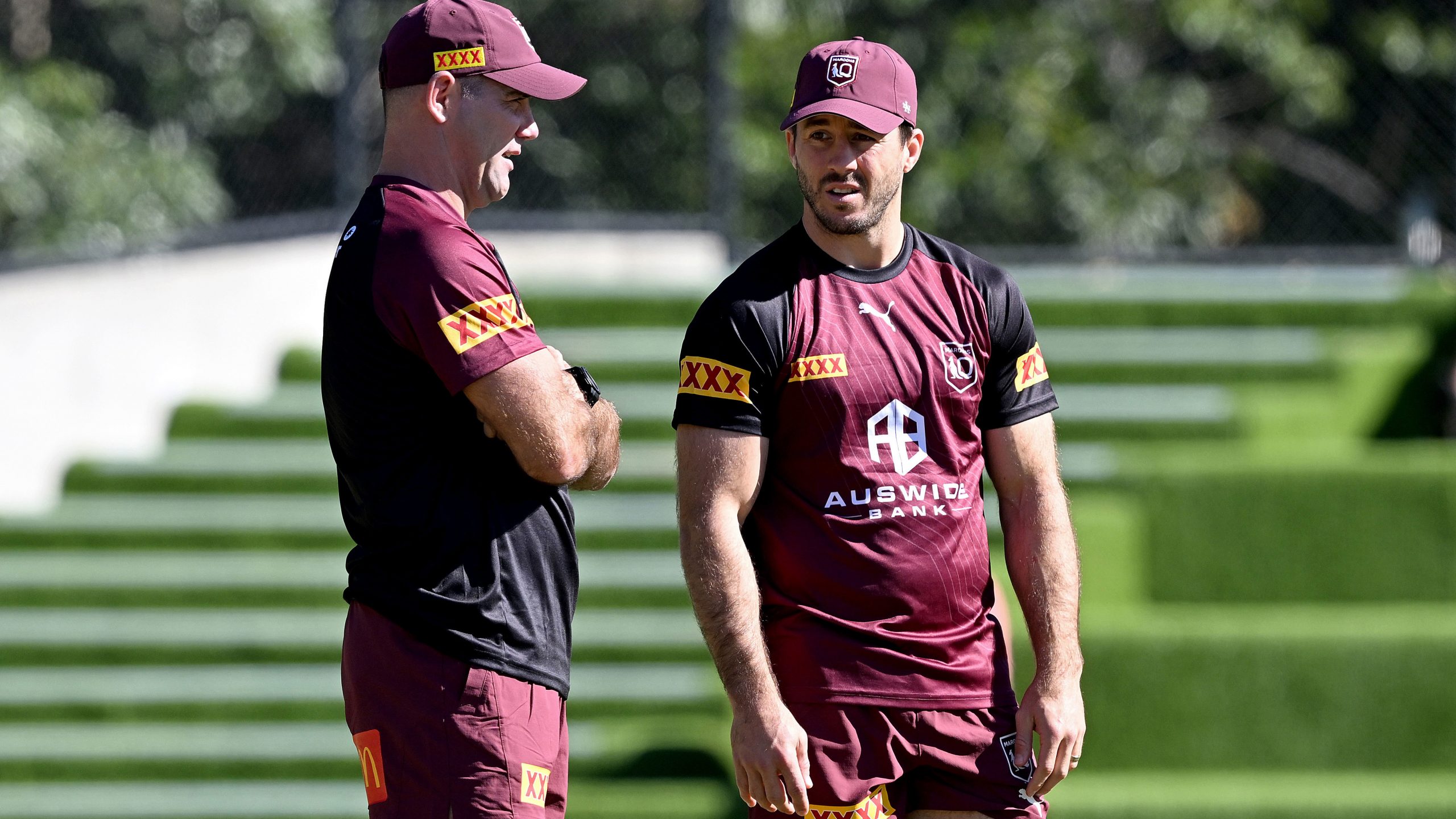 Ben Hunt chats with former Queensland player Cameron Smith during a Maroons State of Origin team training session at the Clive Berghofer Centre on May 23, 2023 in Brisbane, Australia.