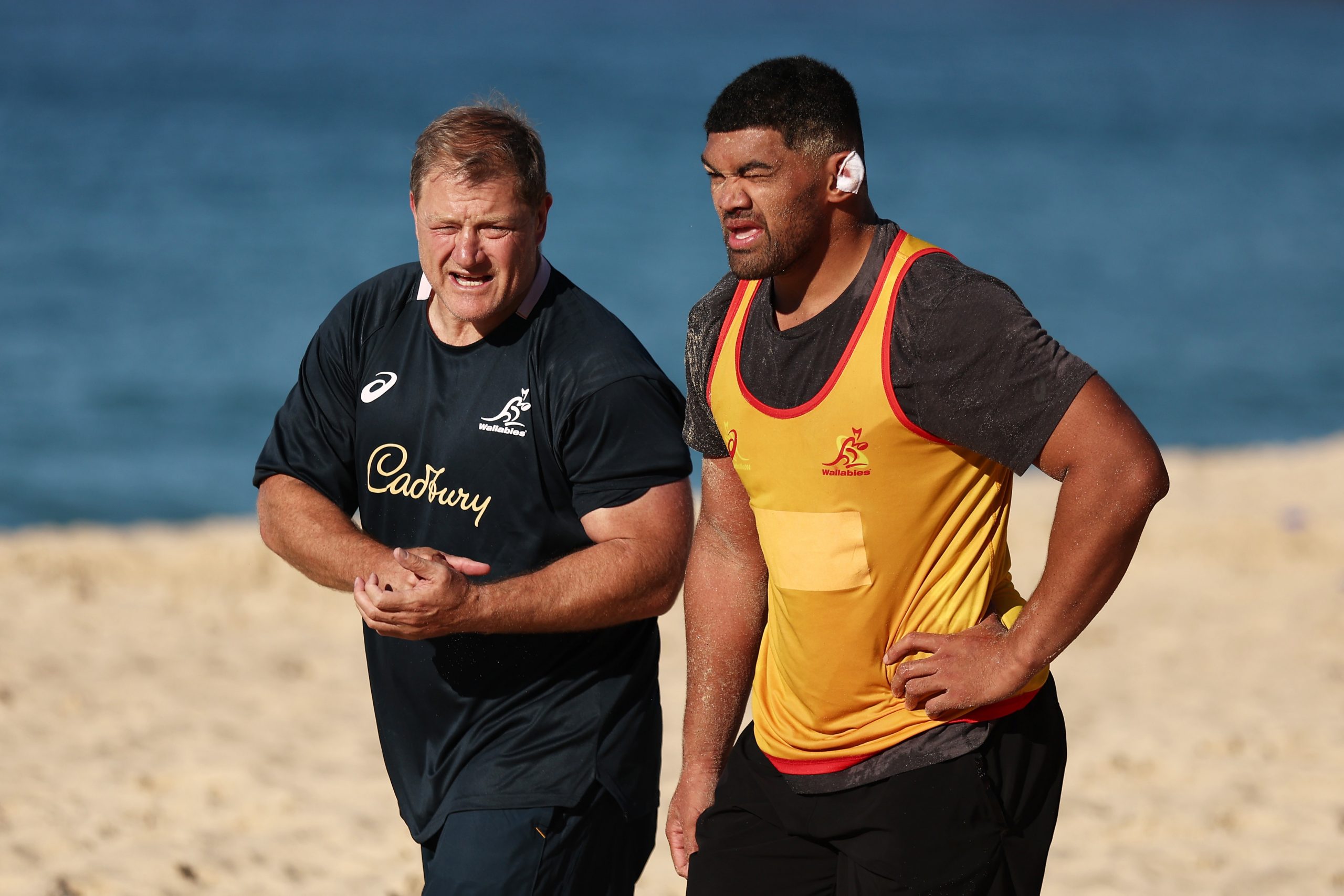 Wallabies scrum coach Neal Hatley talks to Jordan Uelese at Coogee Beach.