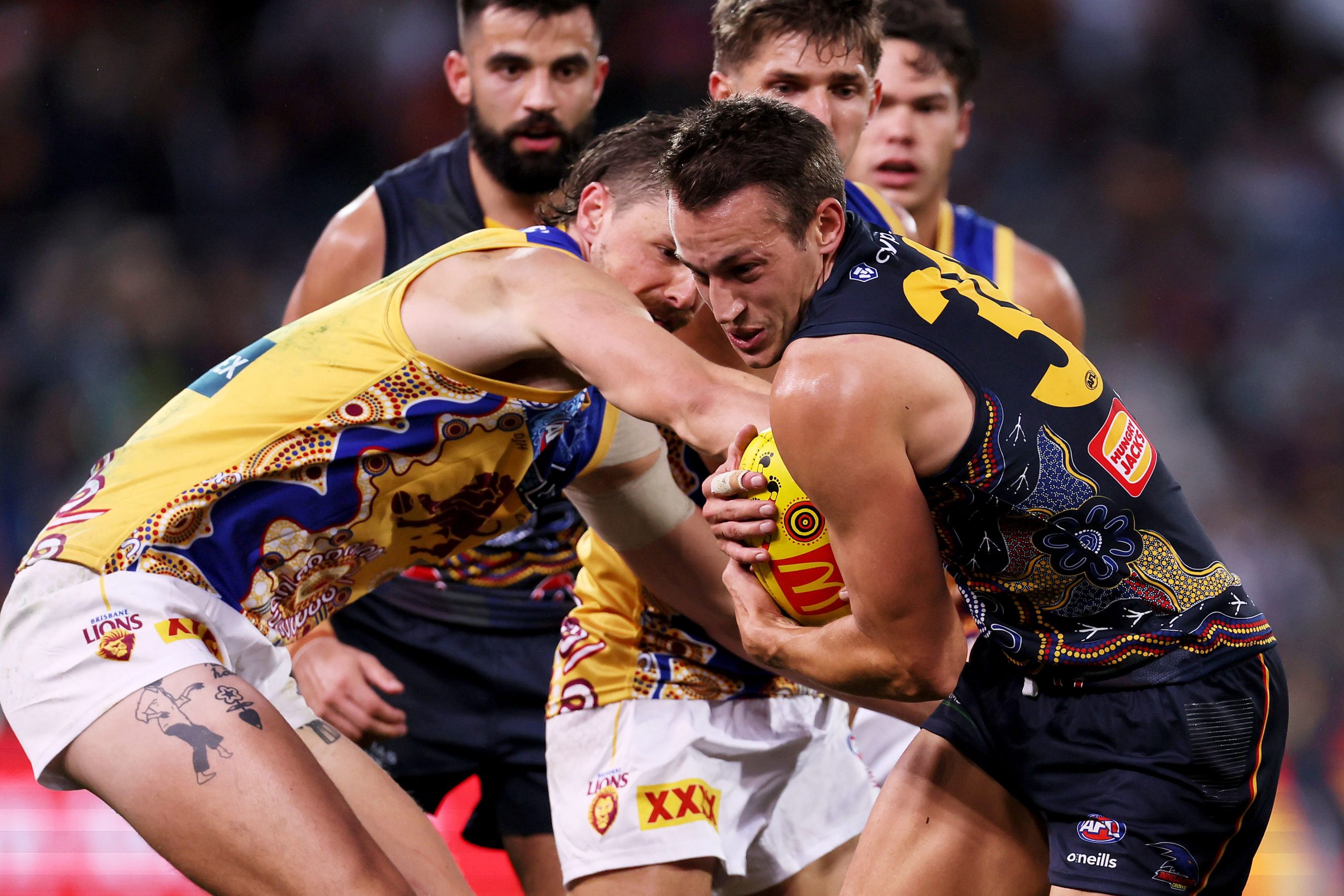 ADELAIDE, AUSTRALIA - MAY 28: Joe Daniher of the Lions tackles Tom Doedee of the Crows during the 2023 AFL Round 11 match between the Adelaide Crows and the Brisbane Lions at Adelaide Oval on May 28, 2023 in Adelaide, Australia. (Photo by James Elsby/AFL Photos)