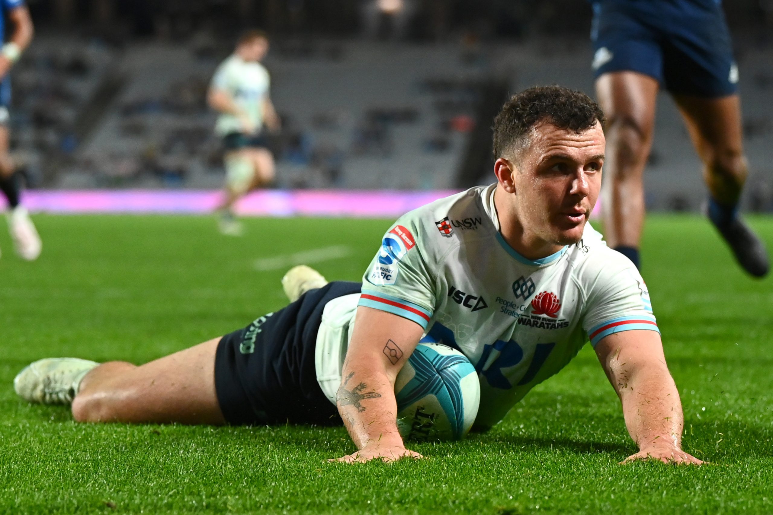 Dylan Pietsch of the Waratahs dives over to score a try at Eden Park.