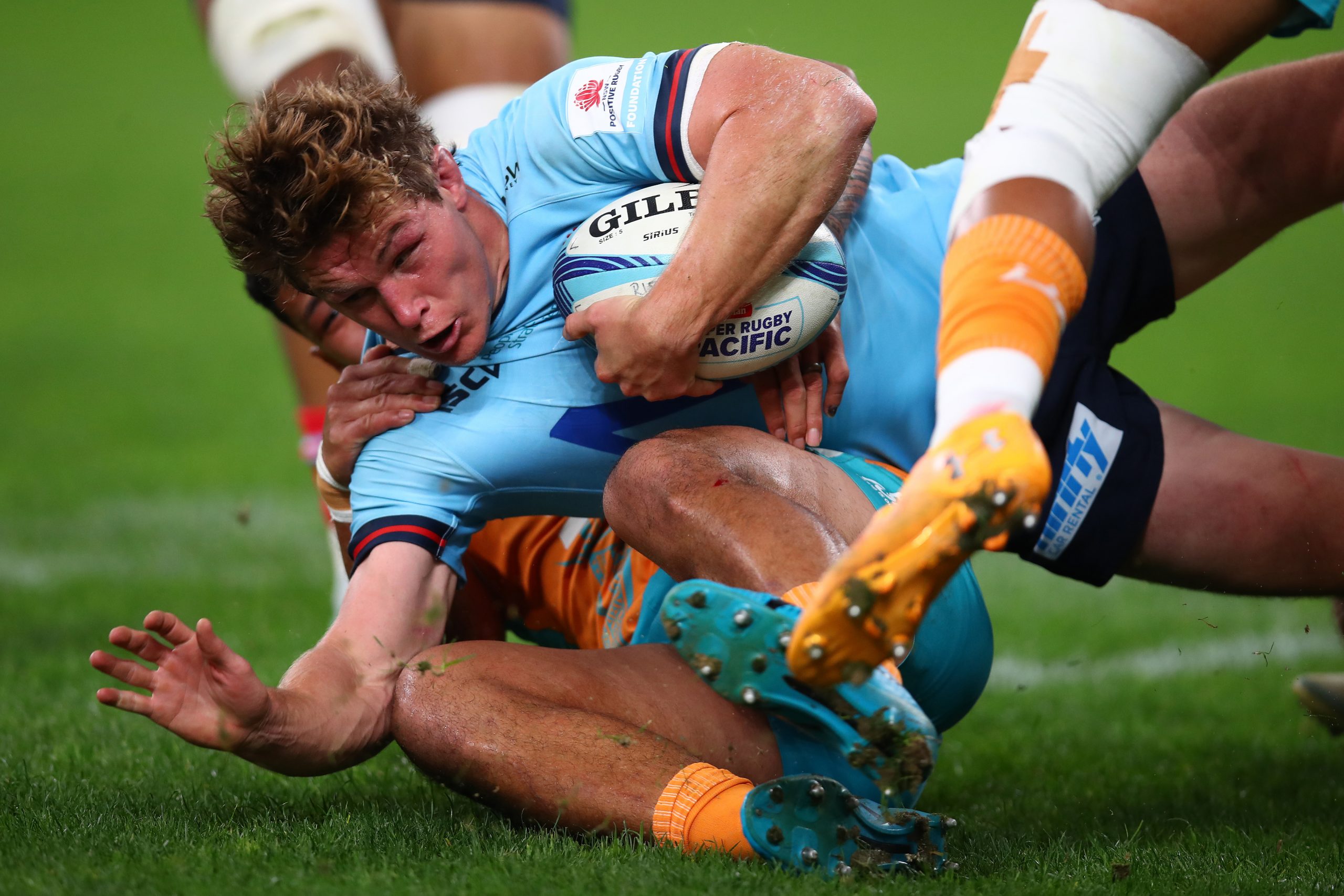 Michael Hooper of the Waratahs is tackled at Allianz Stadium.