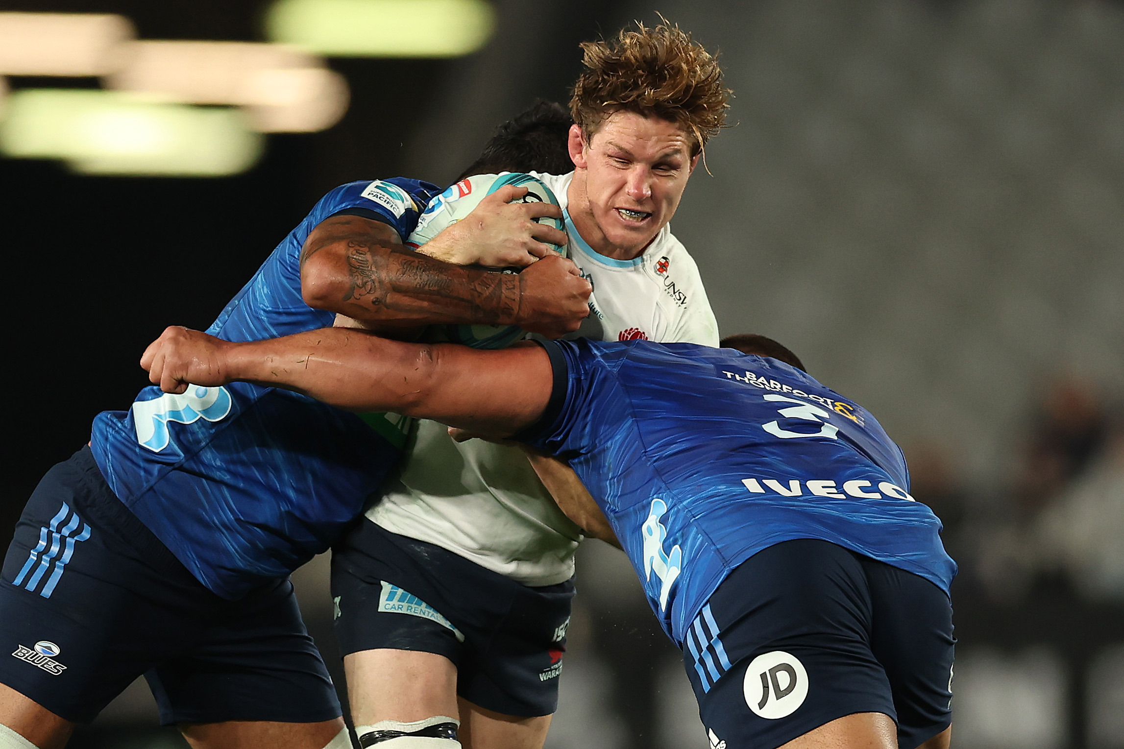 Michael Hooper of the Waratahs is tackled.