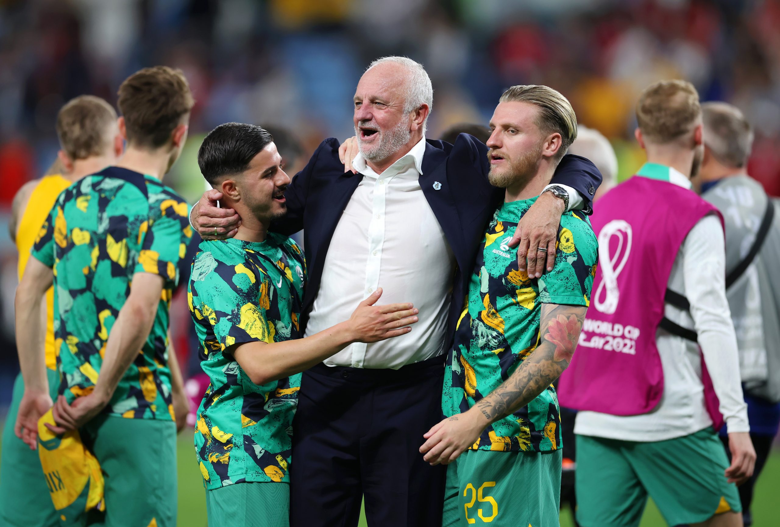 Graham Arnold is congratulated by his players after their 1-0 victory.