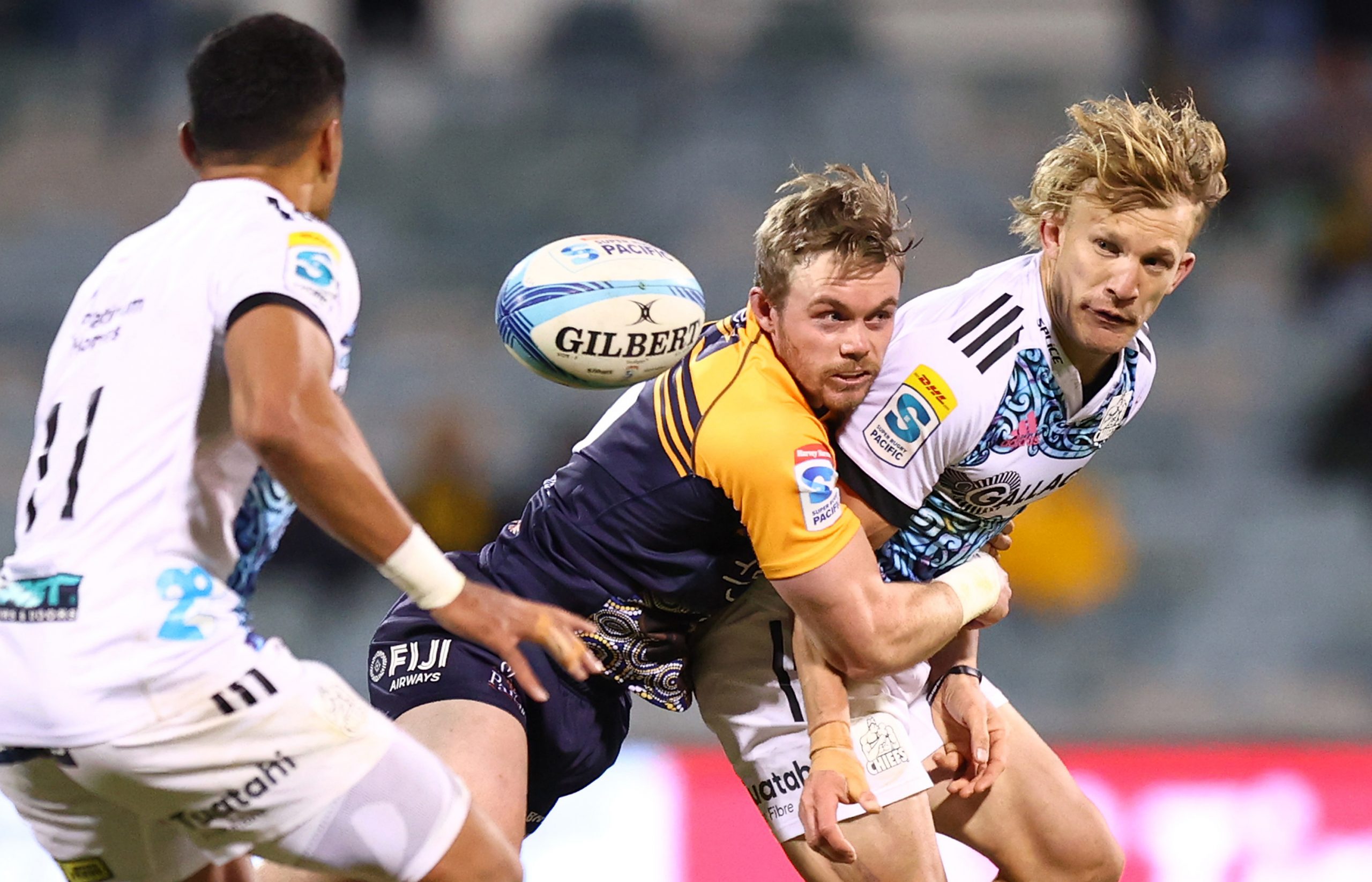 Damien McKenzie of the Chiefs offloads at GIO Stadium.