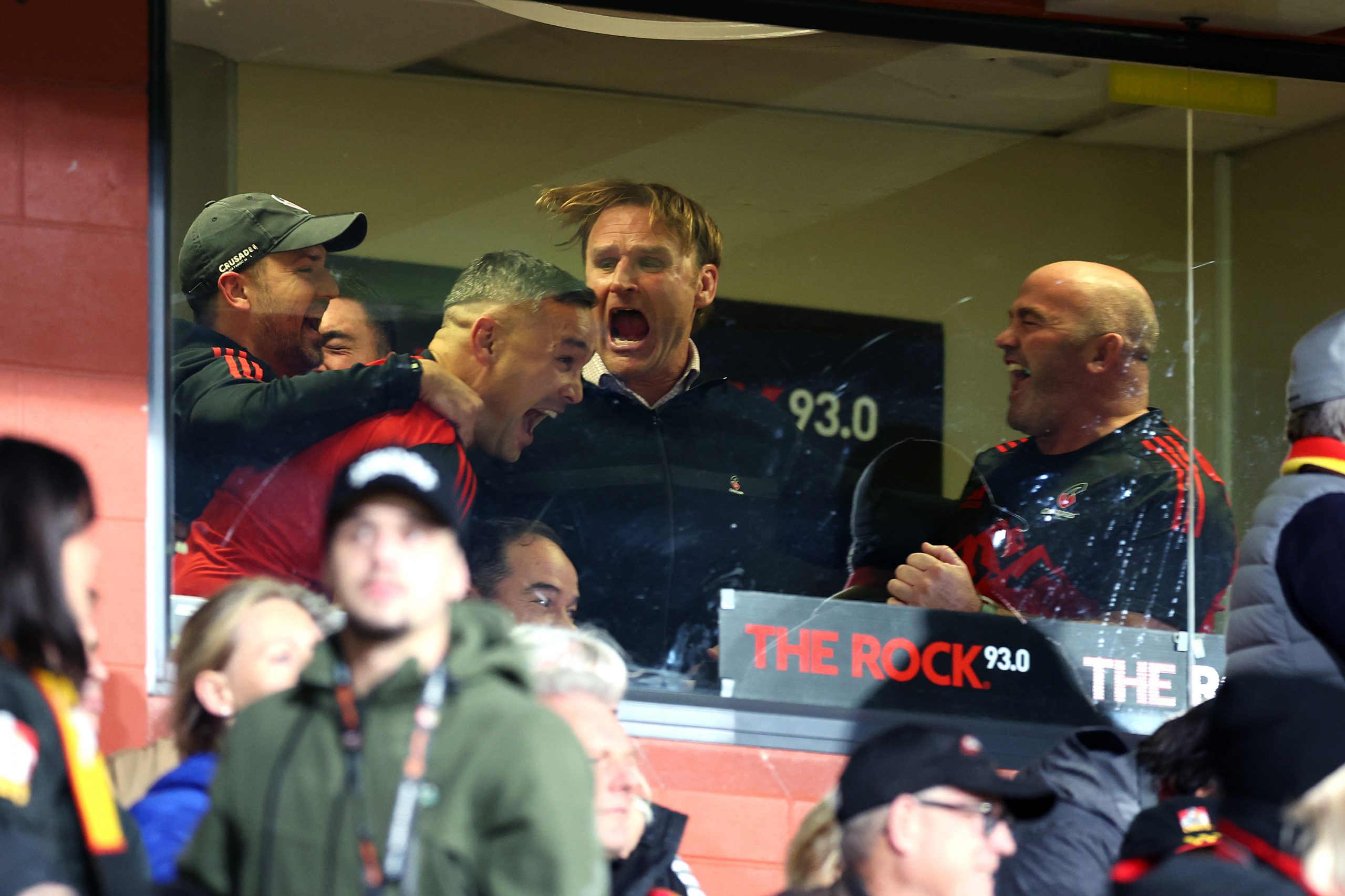 The Crusaders coaching team celebrates after winning.