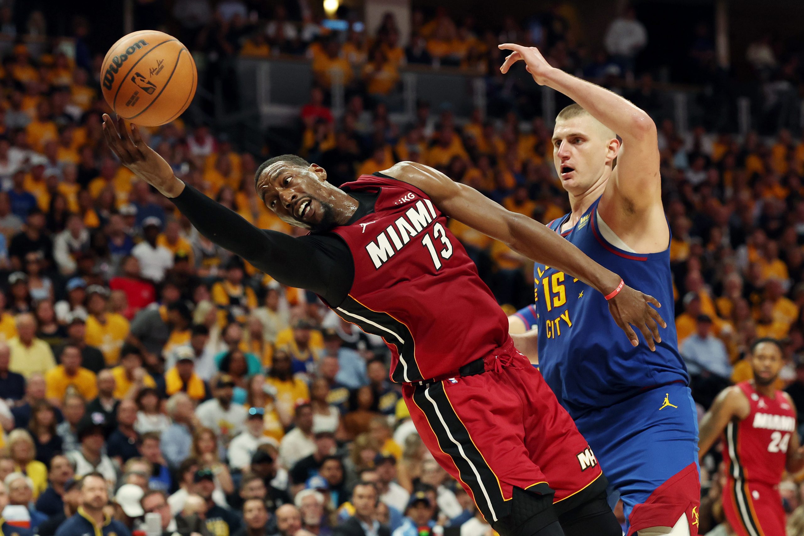 Bam Adebayo of the Miami Heat battles Nikola Jokic of the Denver Nuggets.